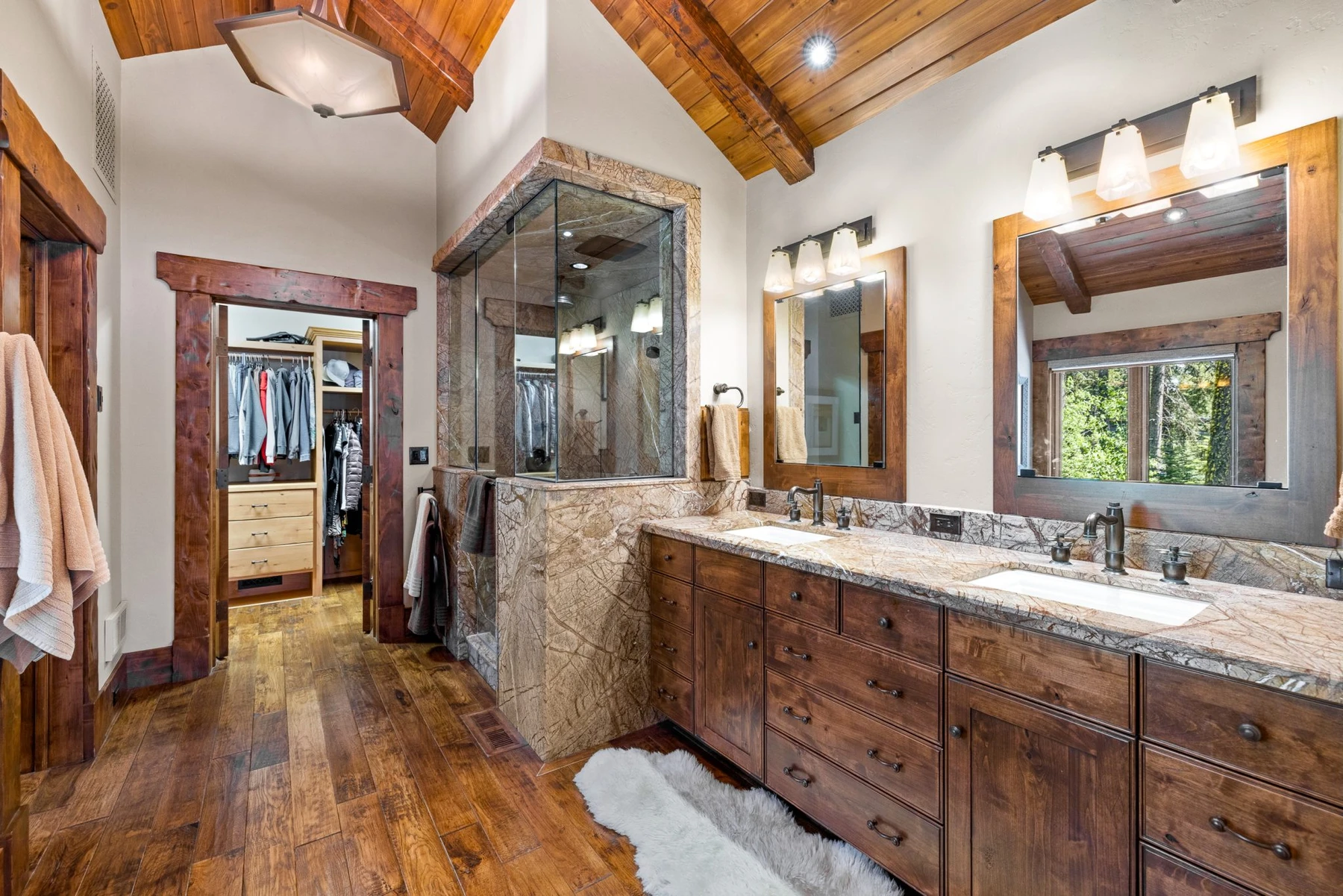 Bathroom in the Rocky Shore lakefront home on Payette Lake, with a custom vanity, wood cabinetry, and natural light.