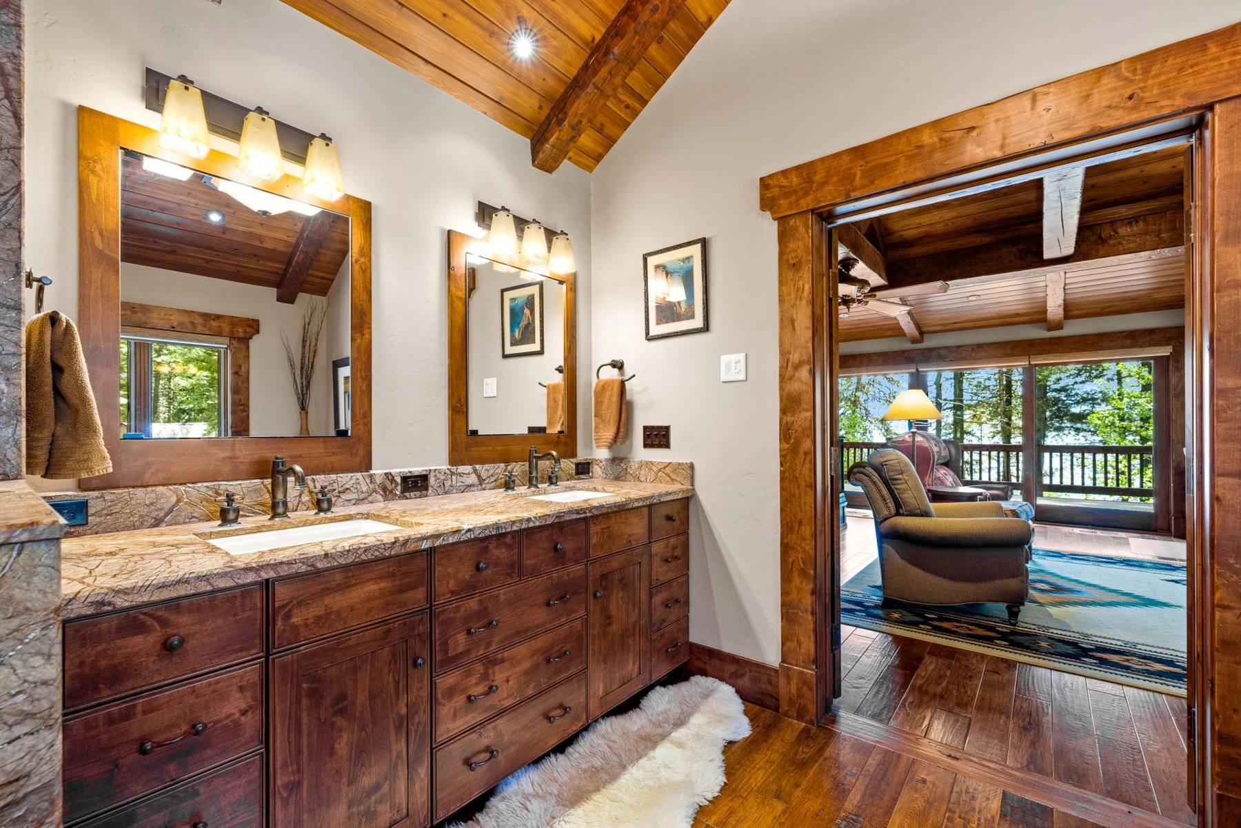 Bathroom in the Rocky Shore lakefront home on Payette Lake, with a custom vanity, wood cabinetry, and natural light.