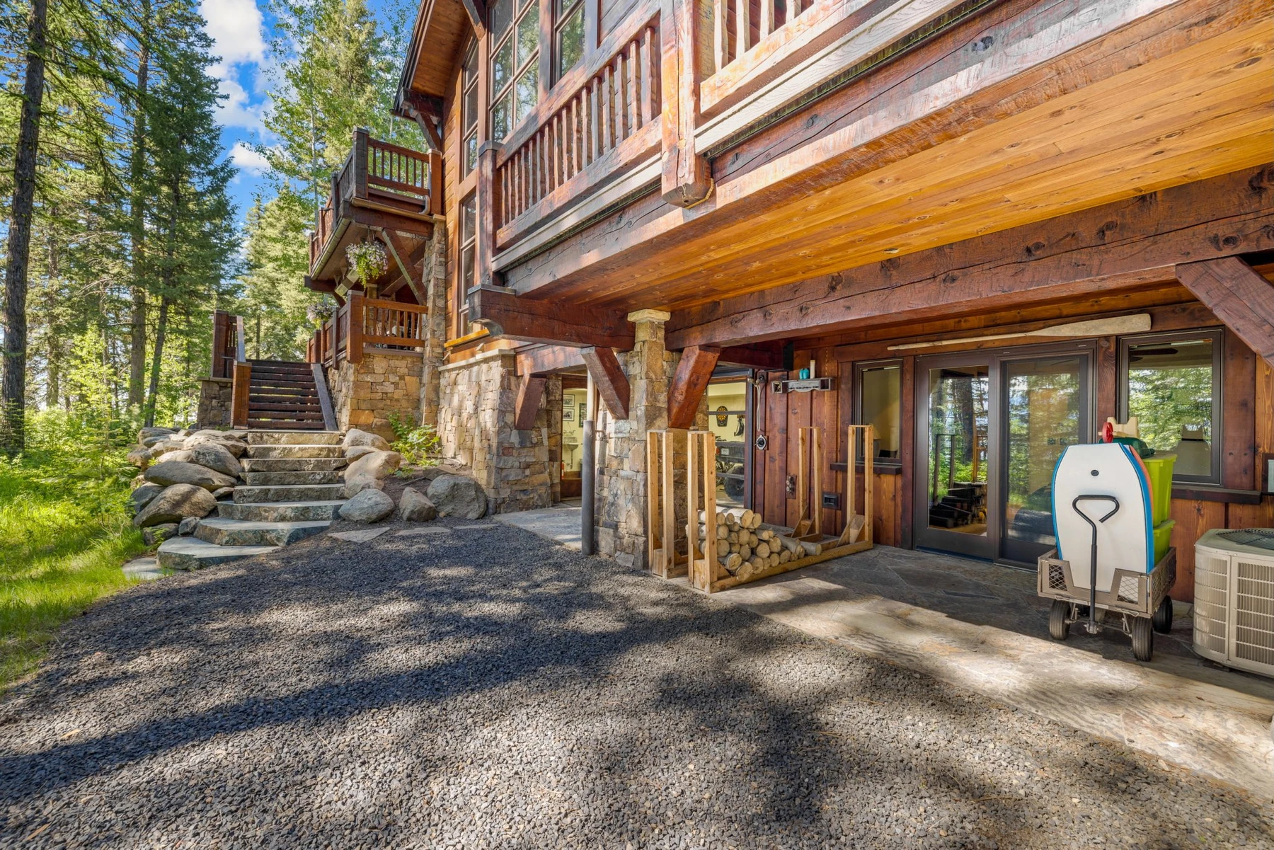 Covered outdoor space at the Rocky Shore lakefront home on Payette Lake, with timber details and forest views.