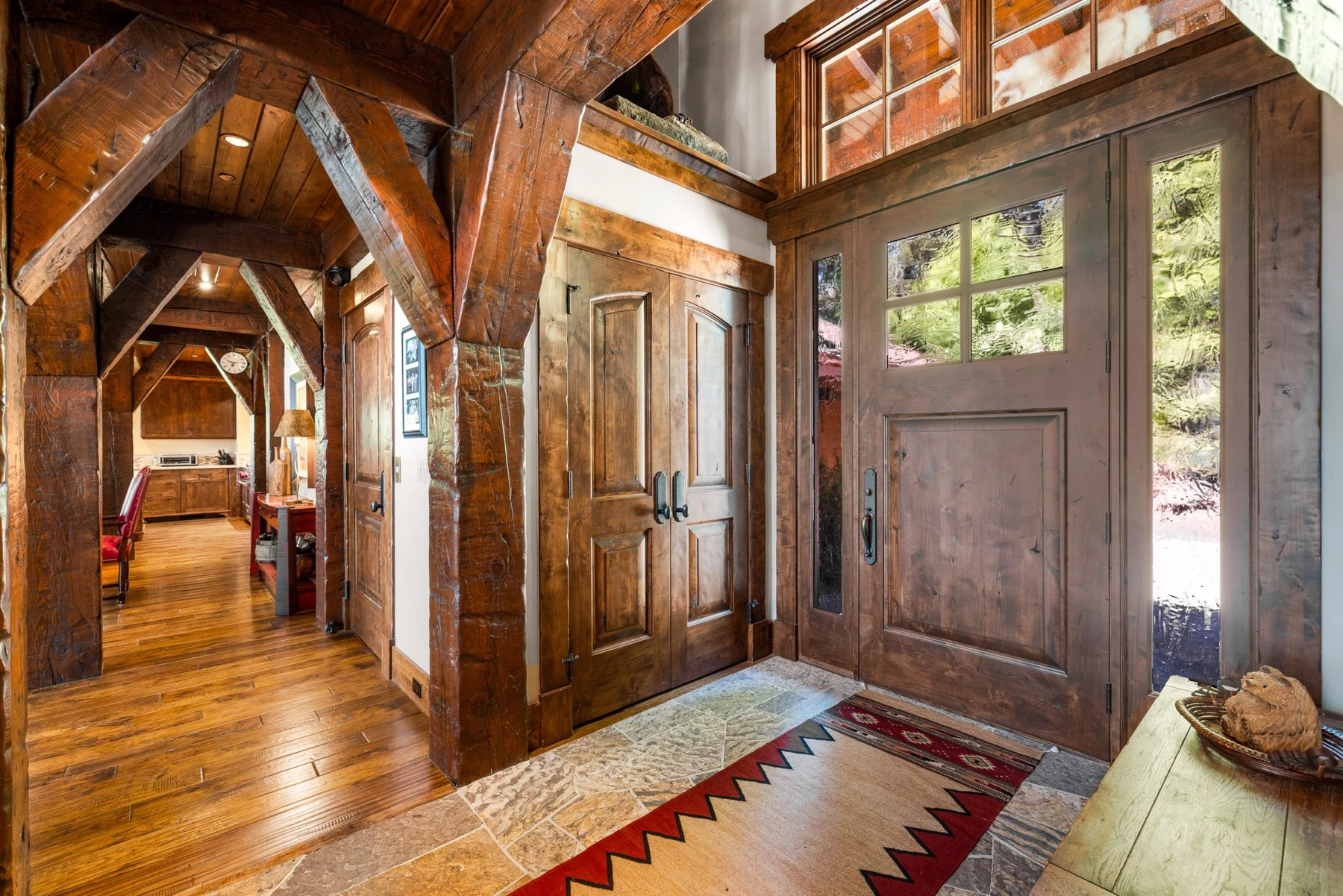 Interior detail in the Rocky Shore lakefront home on Payette Lake, showing large windows and wood finishes.