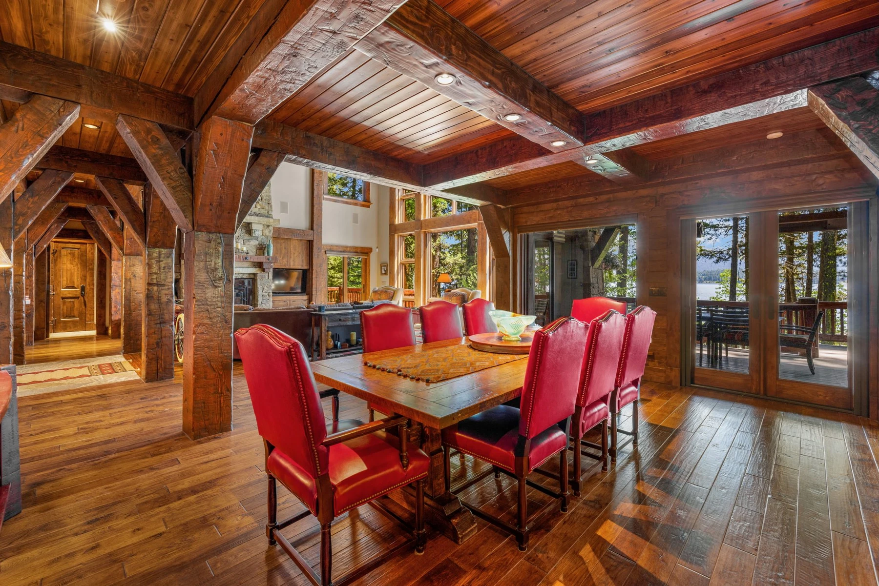 Interior detail in the Rocky Shore lakefront home on Payette Lake, showing large windows, wood finishes, and framed artwork.