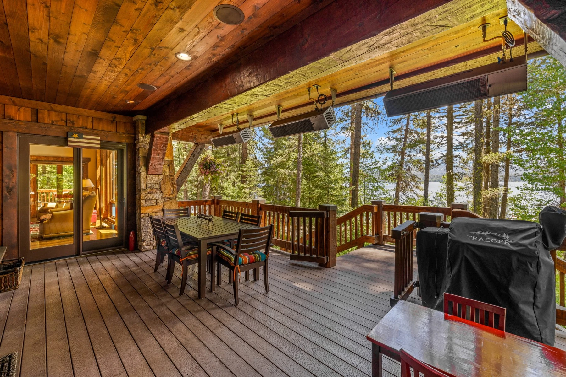 Covered outdoor space at the Rocky Shore lakefront home on Payette Lake, with outdoor seating and timber details.