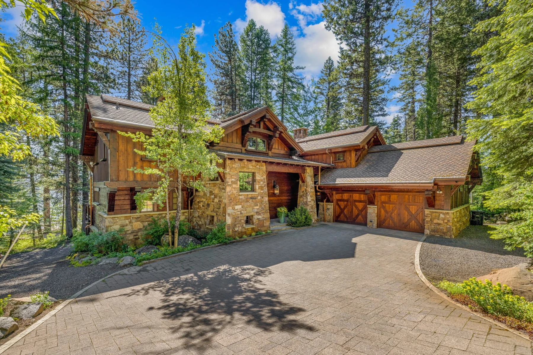 Garage approach at the Rocky Shore lakefront home on Payette Lake, with an attached garage and a broad driveway.