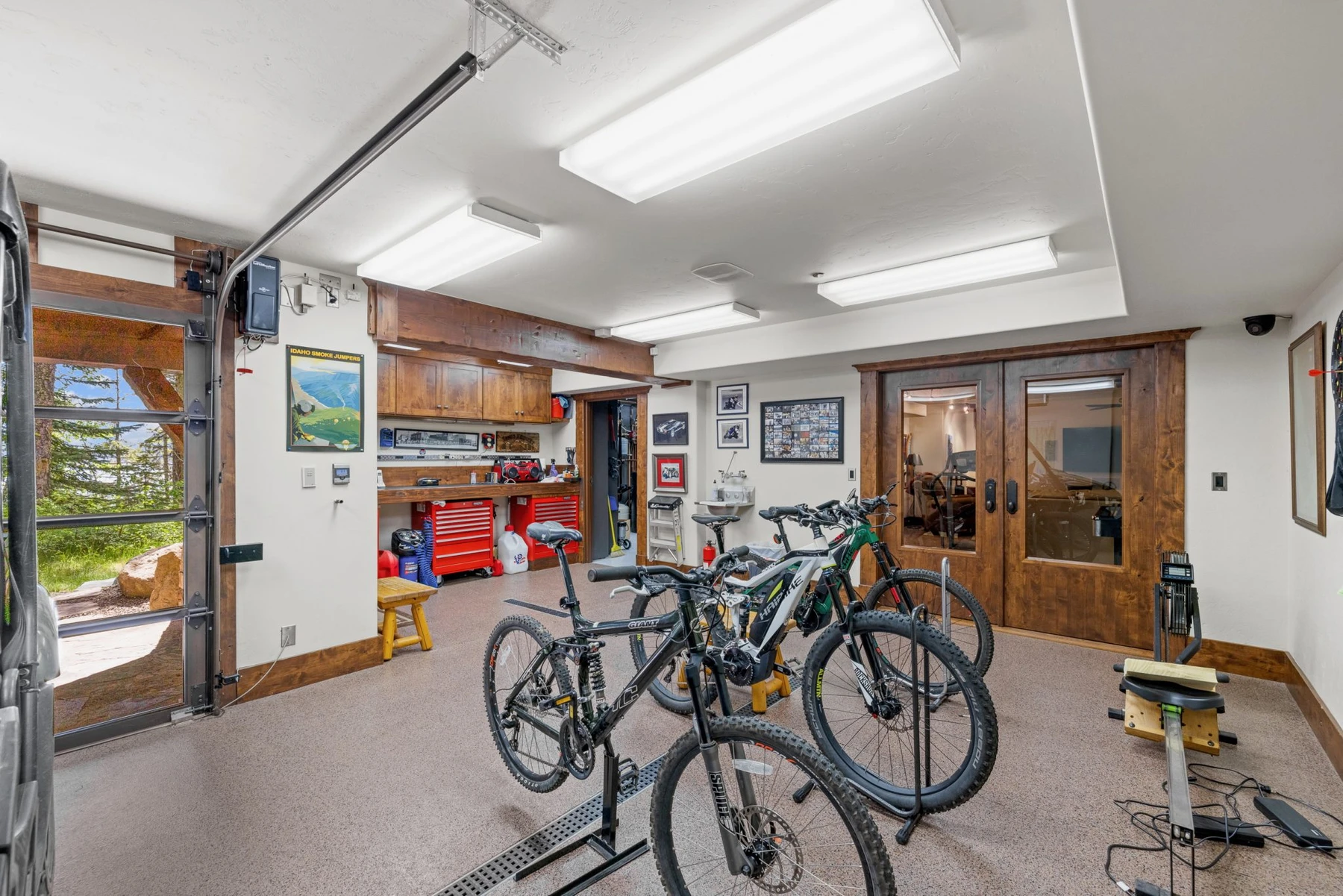 Gear room in the Rocky Shore lakefront home on Payette Lake, with bicycle storage, built-in cabinetry, and glass doors.