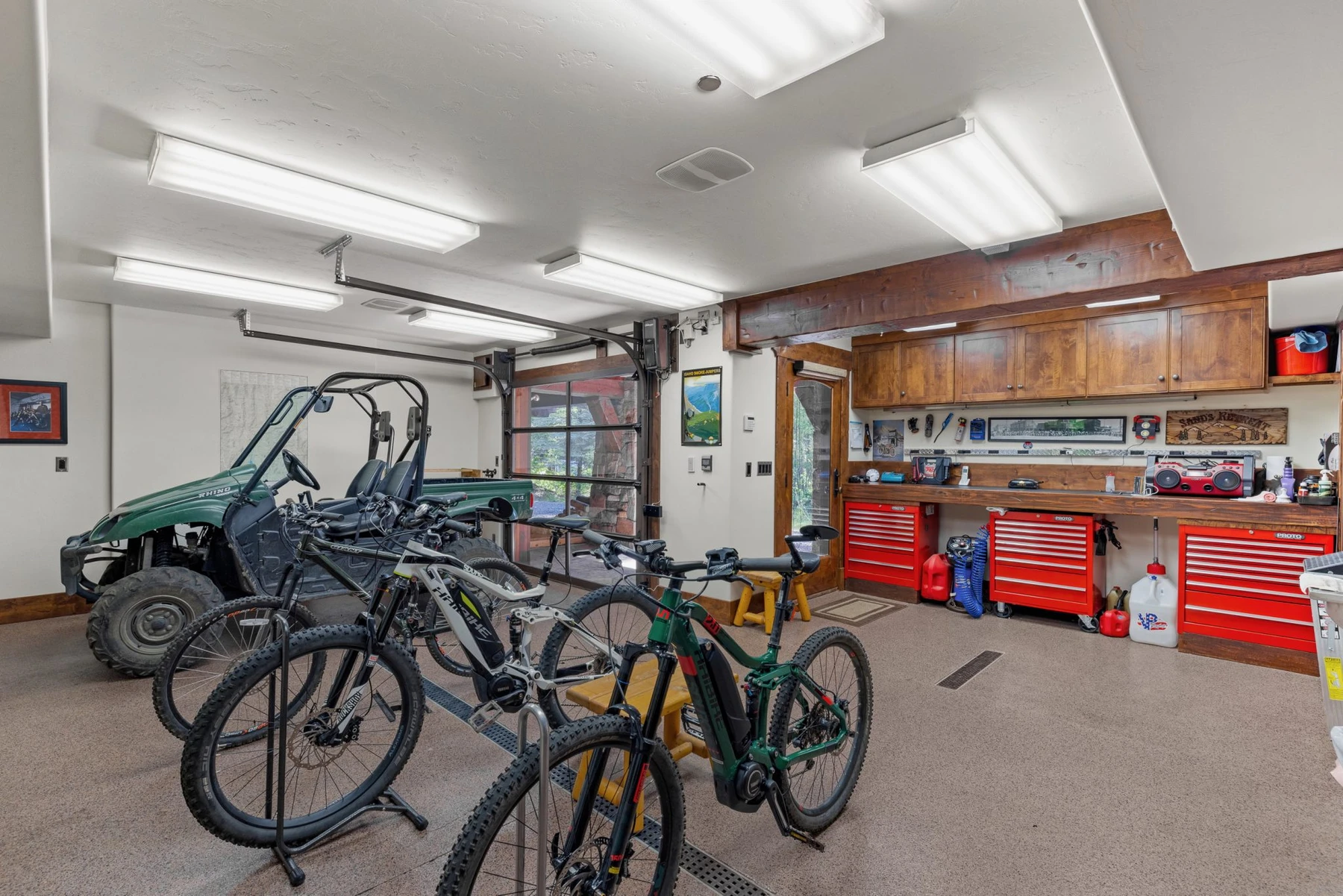 Gear room in the Rocky Shore lakefront home on Payette Lake, with bicycle storage, built-in cabinetry, and glass doors.