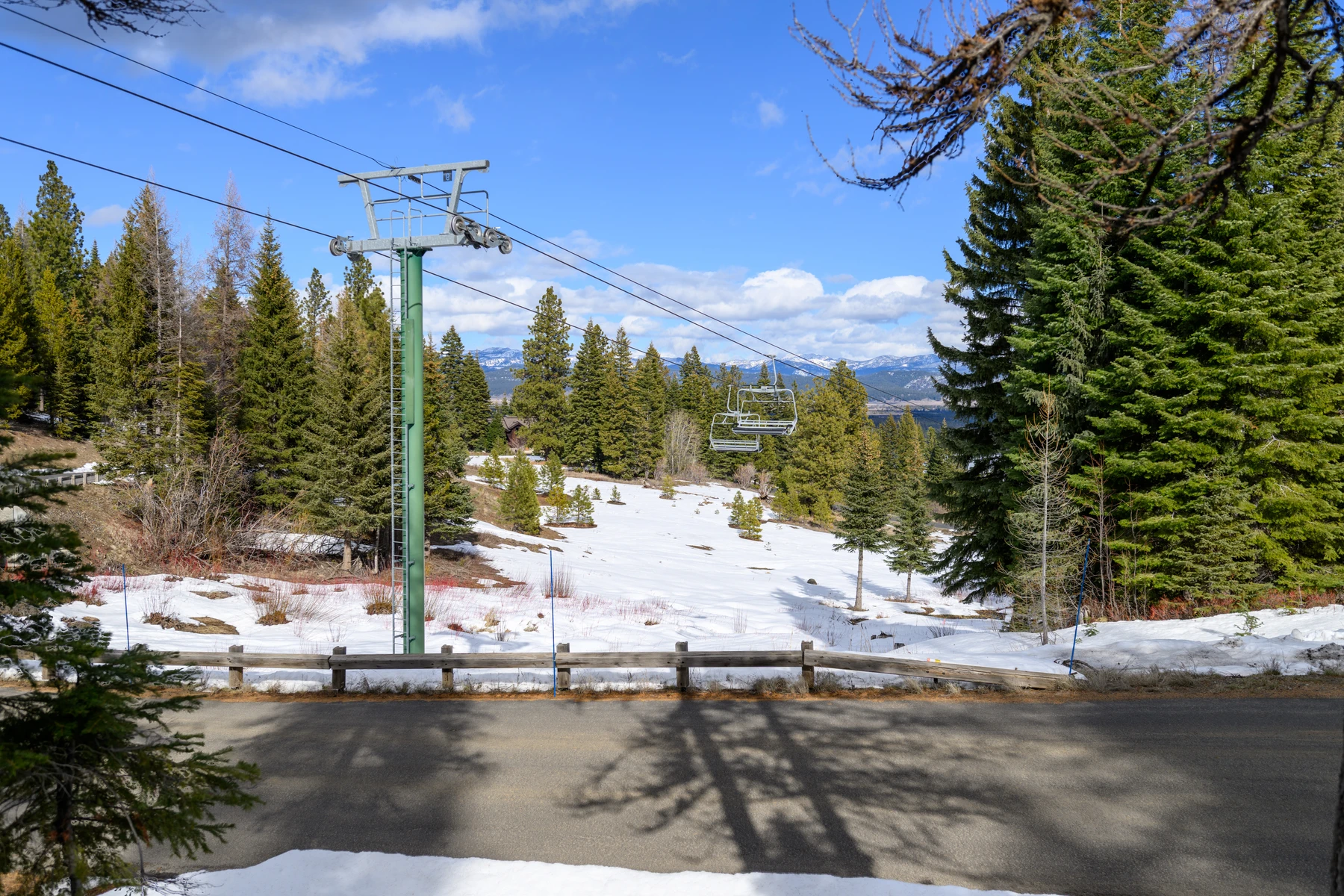 Exterior of the SlopeSide Escape ski home at Tamarack Resort, showing the surrounding forest and snow-covered grounds.