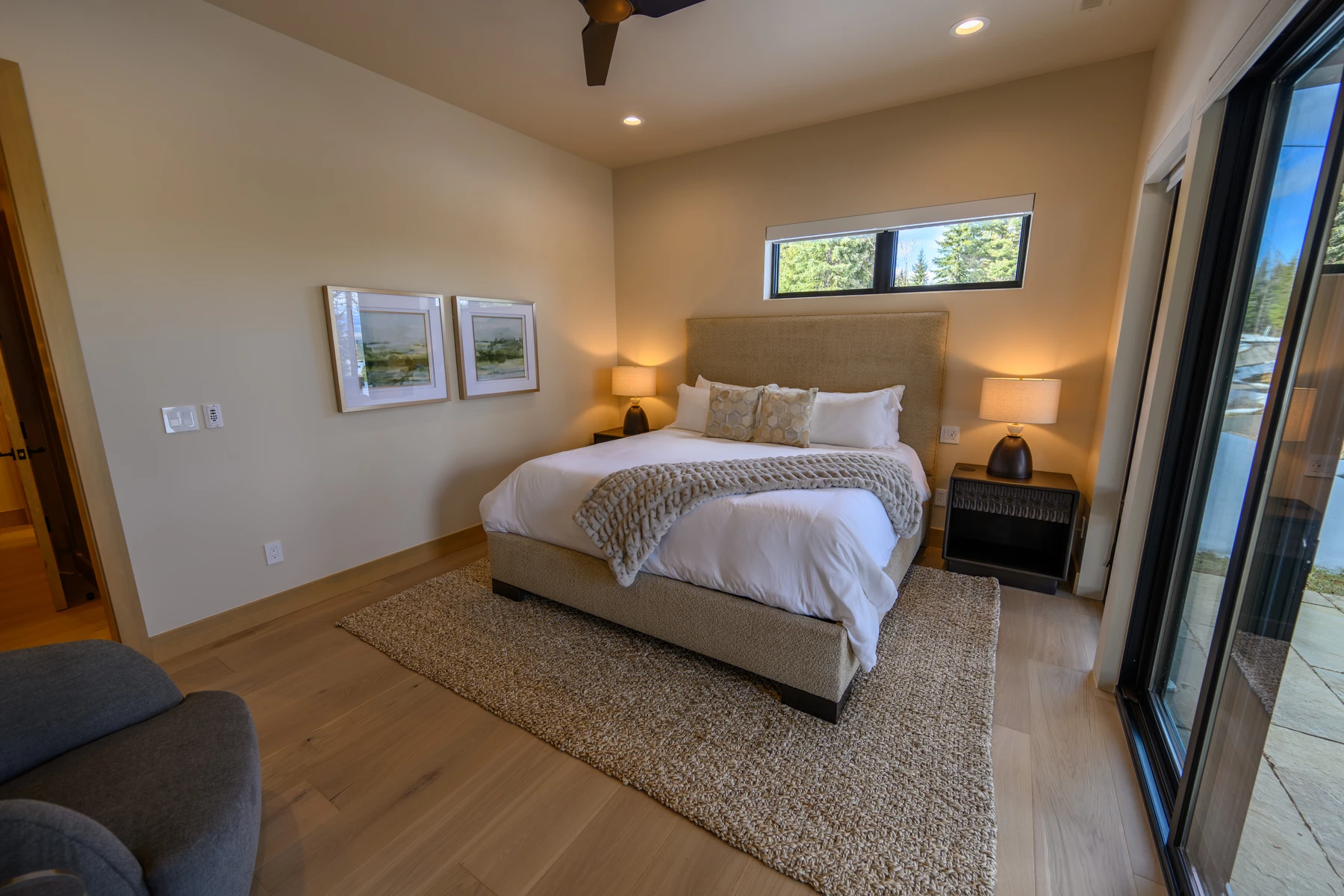 Bedroom in the SlopeSide Escape ski home at Tamarack Resort, with a layered bed and wood details.