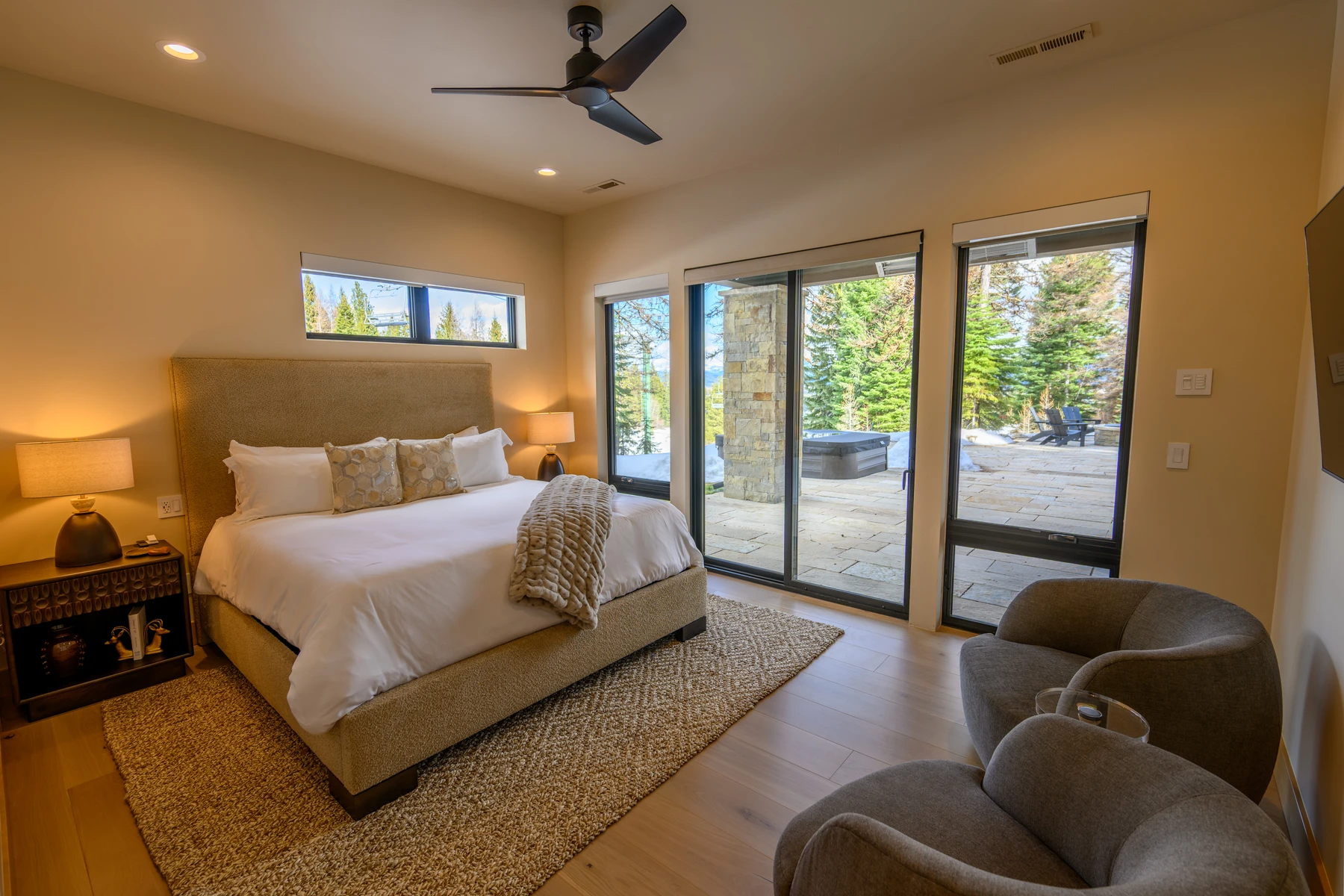Bedroom in the SlopeSide Escape ski home at Tamarack Resort, with a layered bed, large windows, and wood details.