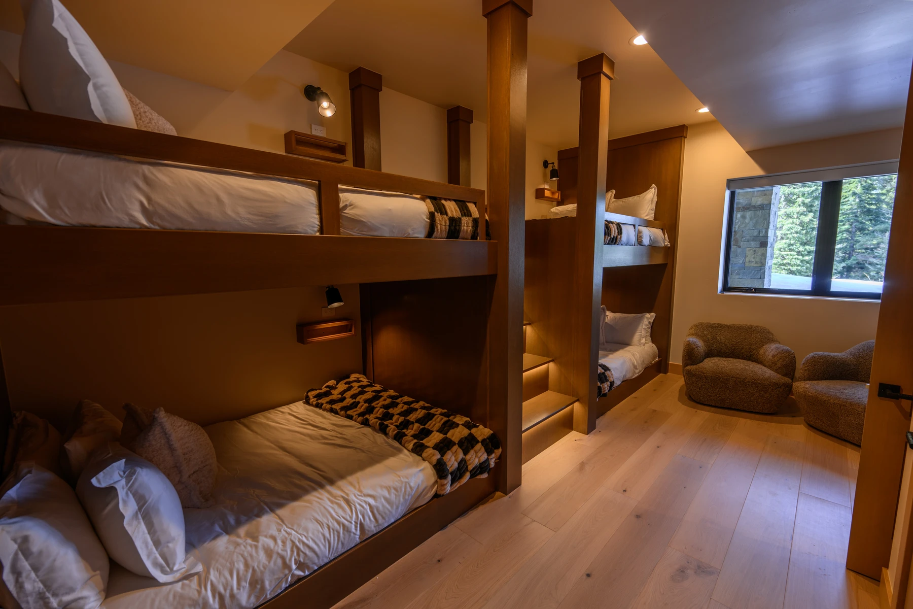 Bedroom in the SlopeSide Escape ski home at Tamarack Resort, with a layered bed, large windows, and wood details.