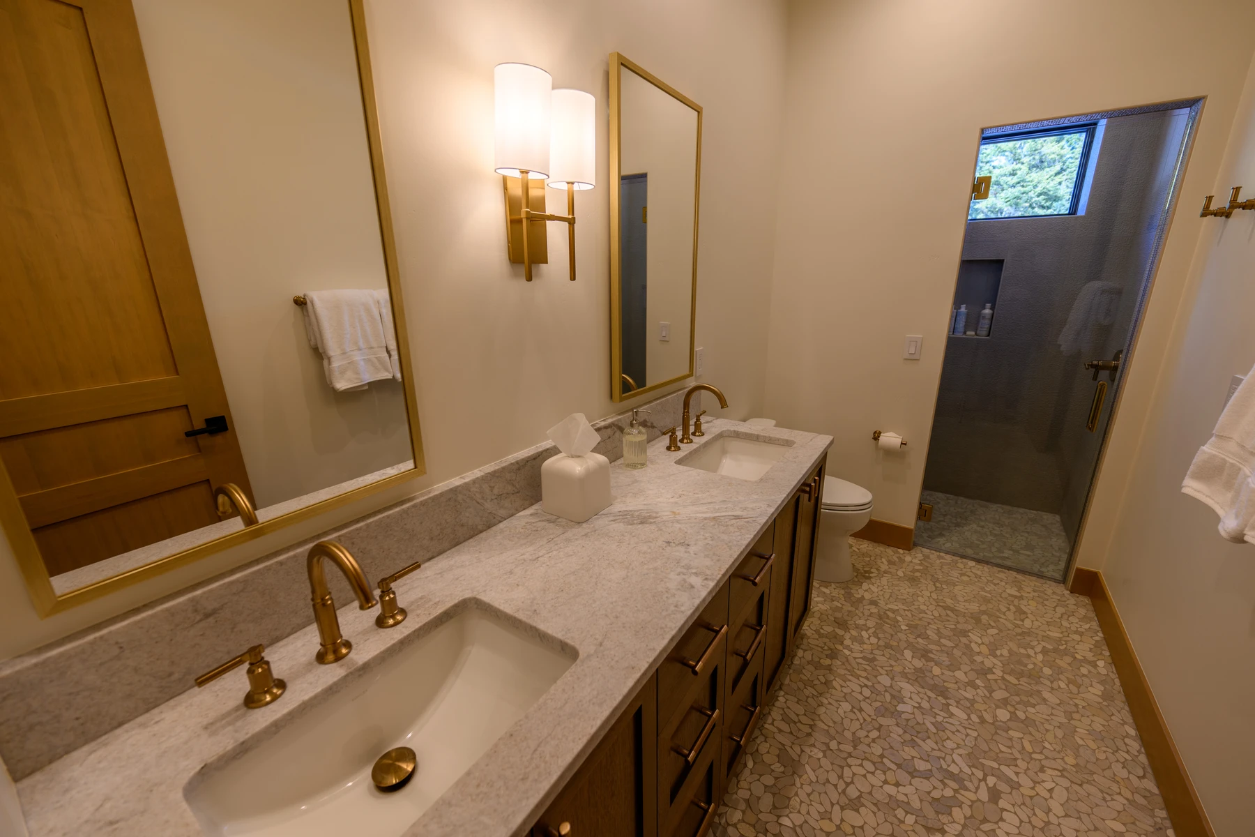 Bathroom in the SlopeSide Escape ski home at Tamarack Resort, with a soaking tub, a custom vanity, and wood cabinetry.