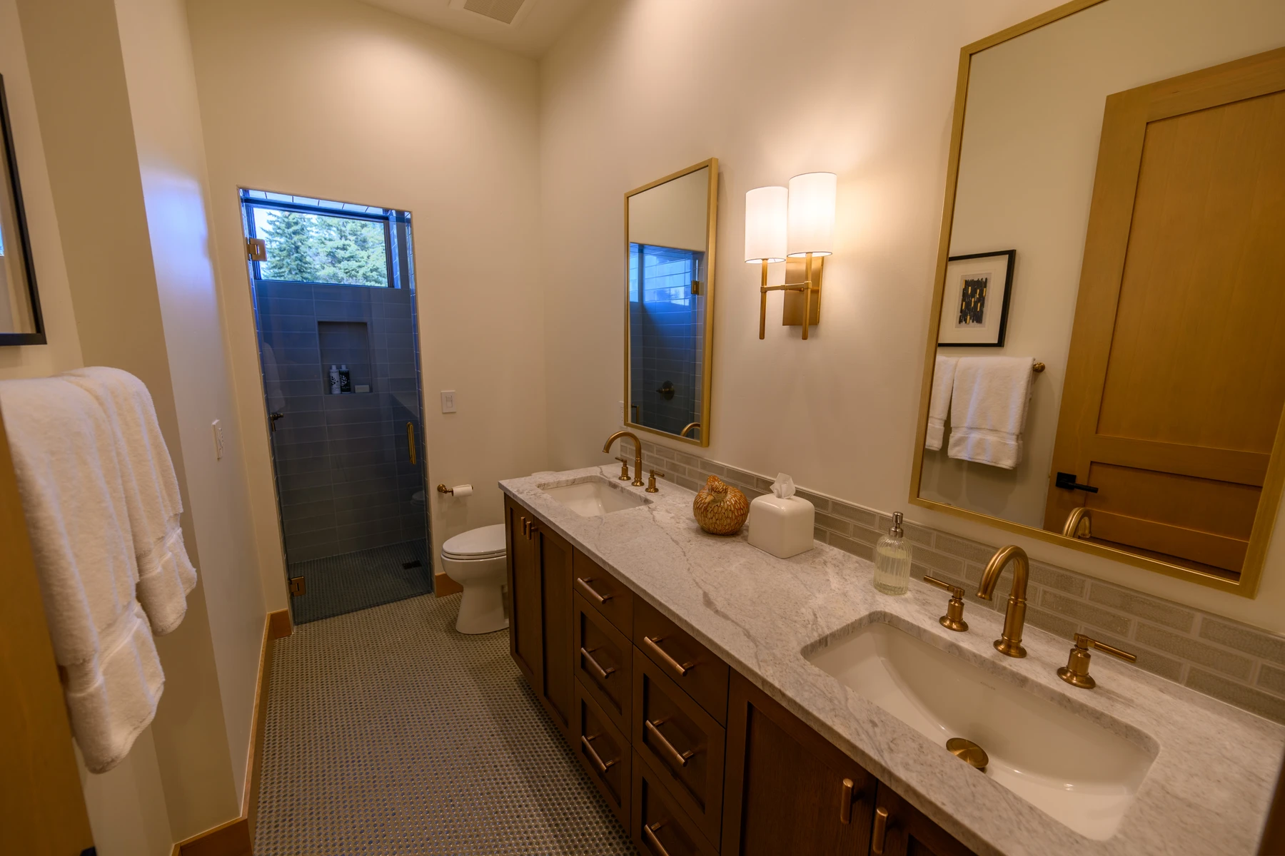 Bathroom in the SlopeSide Escape ski home at Tamarack Resort, with a soaking tub, a custom vanity, and wood cabinetry.