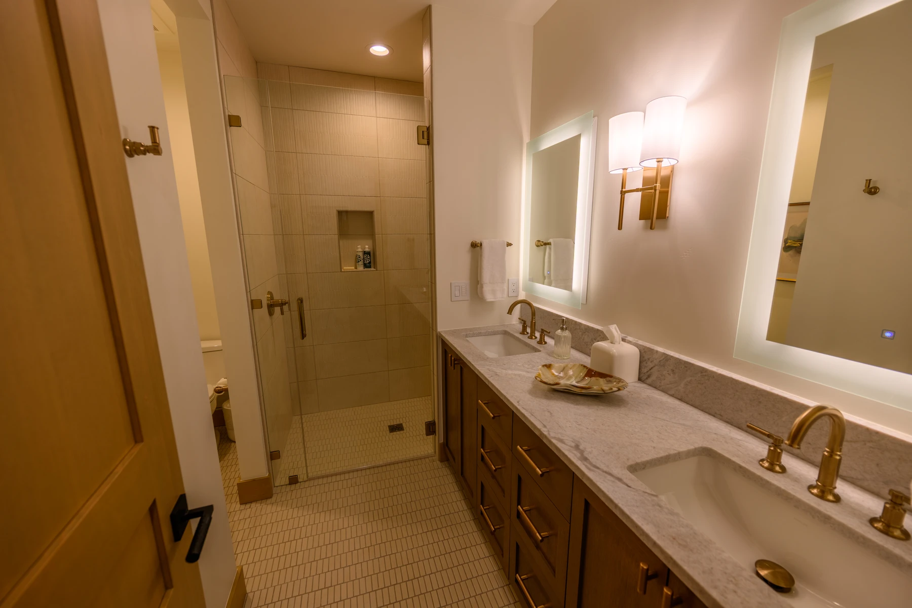 Bathroom in the SlopeSide Escape ski home at Tamarack Resort, with a soaking tub, a glass shower, and a custom vanity.