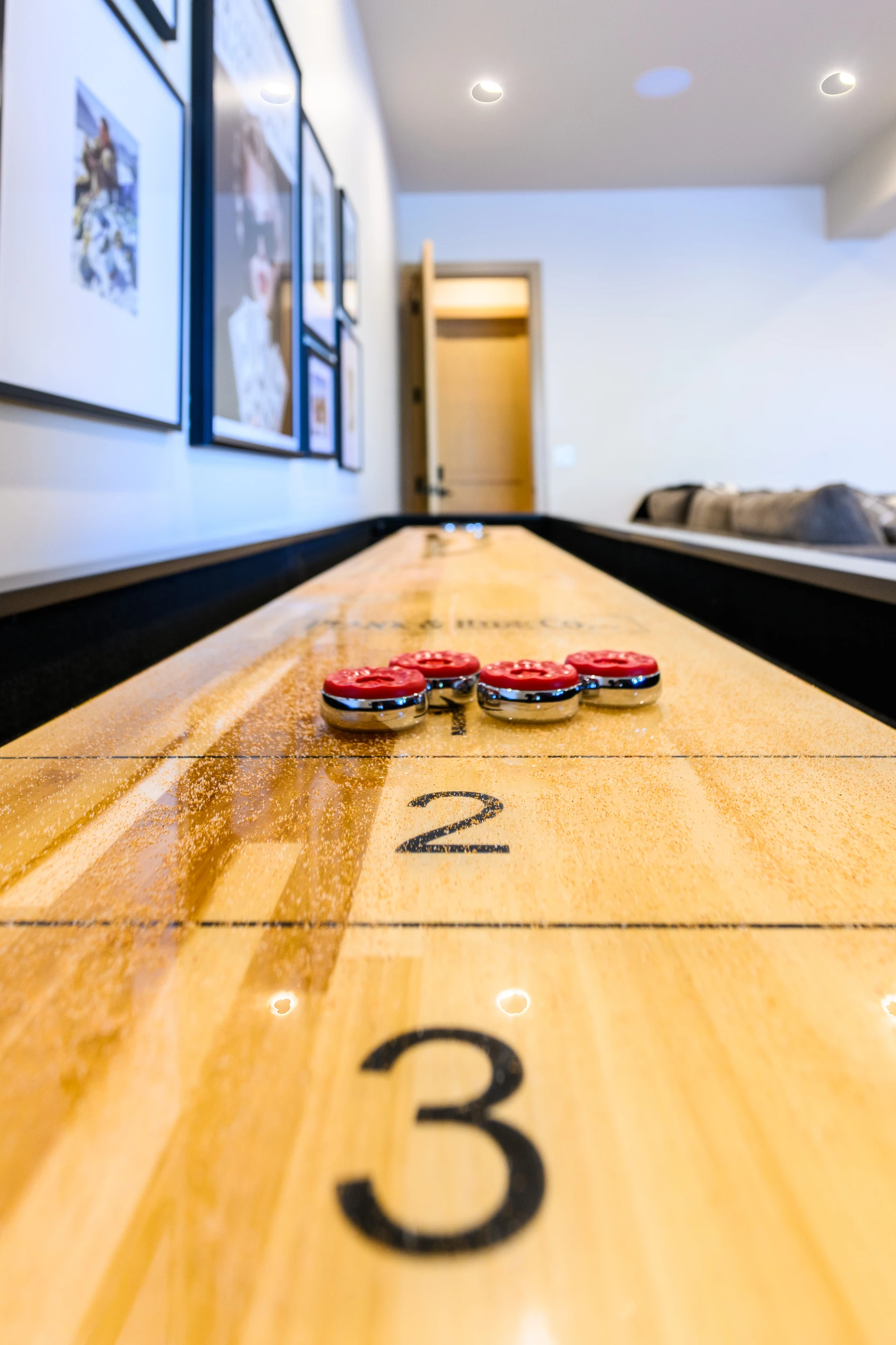 Interior detail in the SlopeSide Escape ski home at Tamarack Resort, showing wood finishes and framed artwork.
