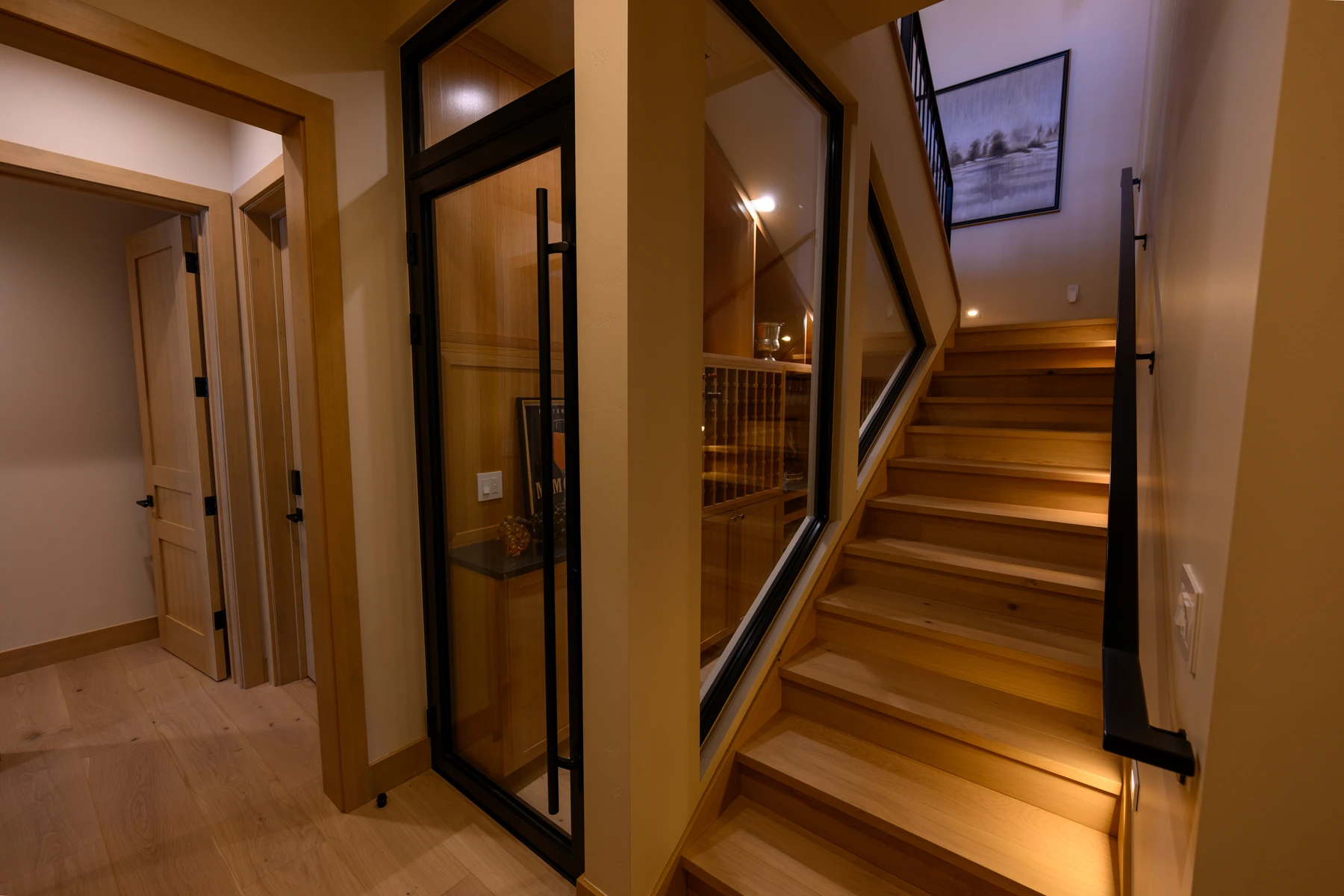 Stair hall in the SlopeSide Escape ski home at Tamarack Resort, with a custom staircase and wood railings.