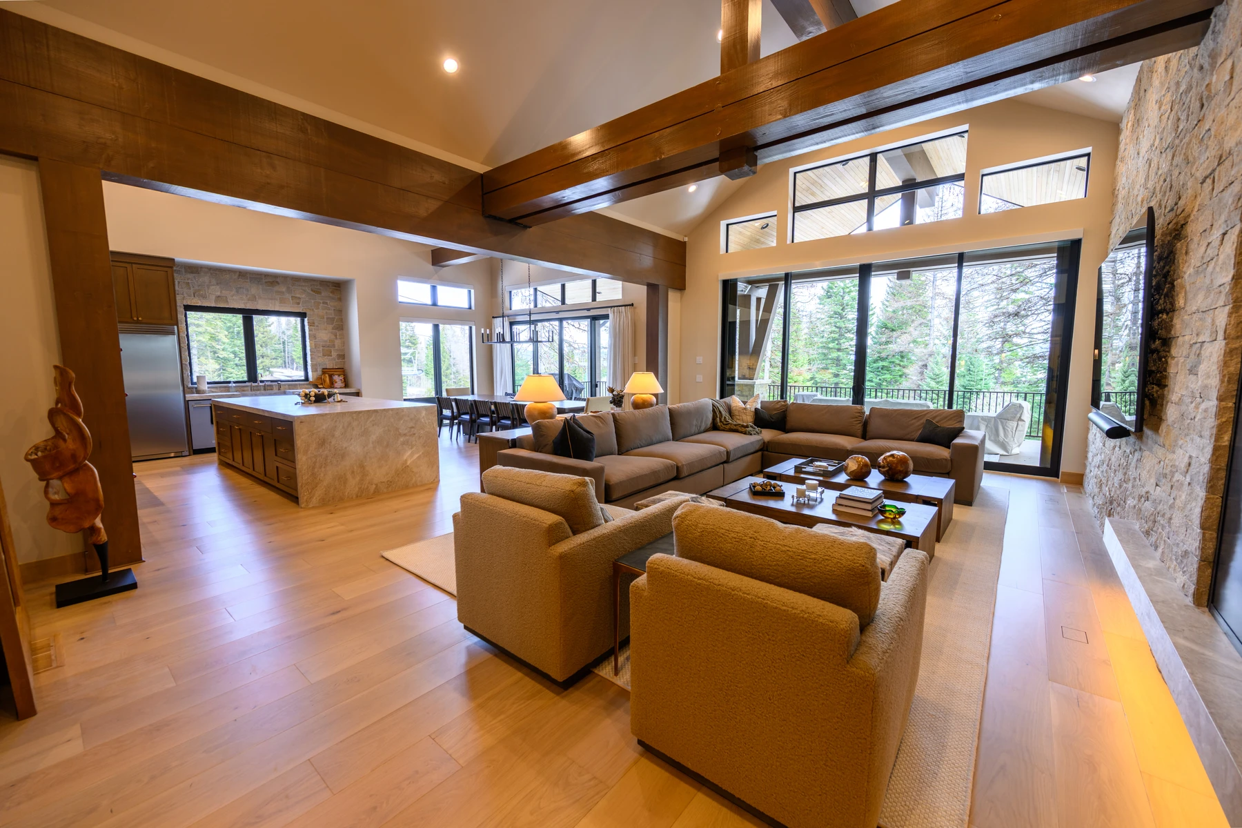 Living room in the SlopeSide Escape ski home at Tamarack Resort, with a relaxed seating area, large windows, and warm wood finishes.
