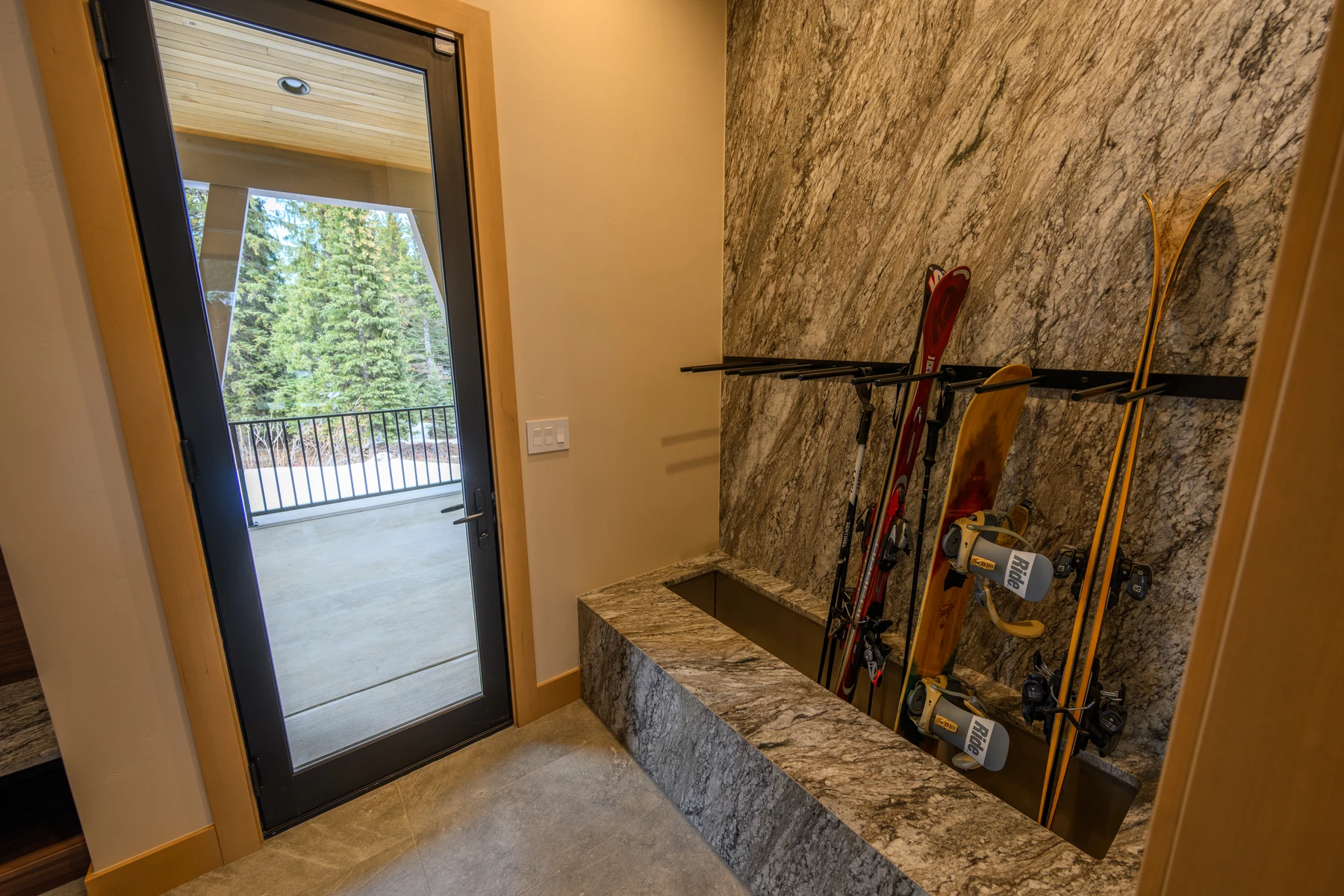 Interior detail in the SlopeSide Escape ski home at Tamarack Resort, showing large windows and wood finishes.
