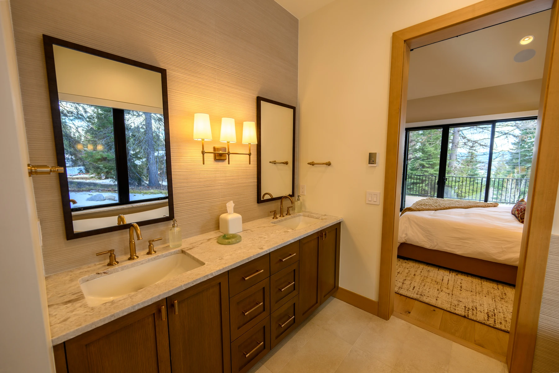 Bathroom in the SlopeSide Escape ski home at Tamarack Resort, with a custom vanity, wood cabinetry, and natural light.
