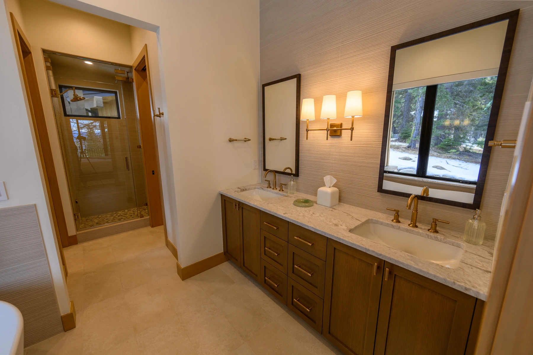 Bathroom in the SlopeSide Escape ski home at Tamarack Resort, with a custom vanity, wood cabinetry, and natural light.