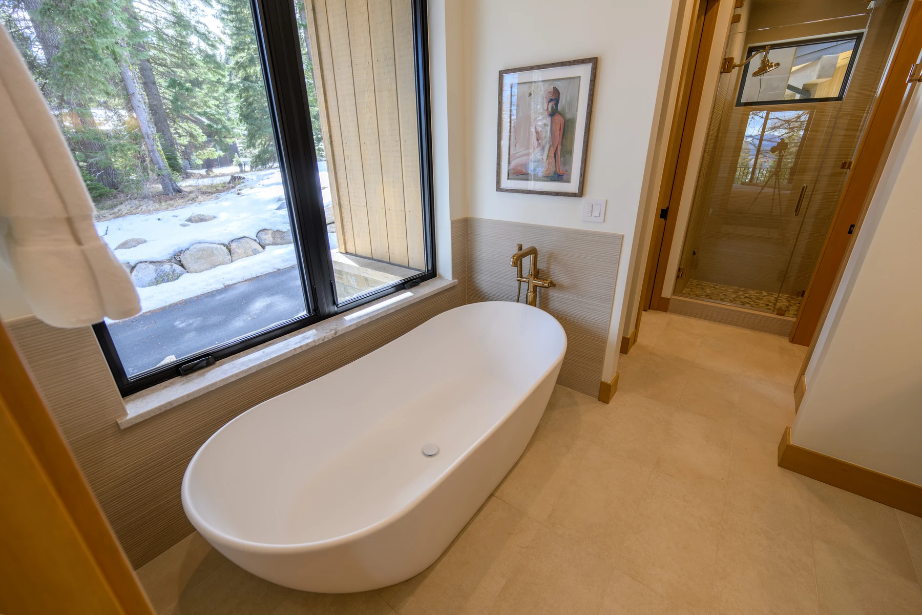 Bathroom in the SlopeSide Escape ski home at Tamarack Resort, with a soaking tub, a custom vanity, and wood cabinetry.