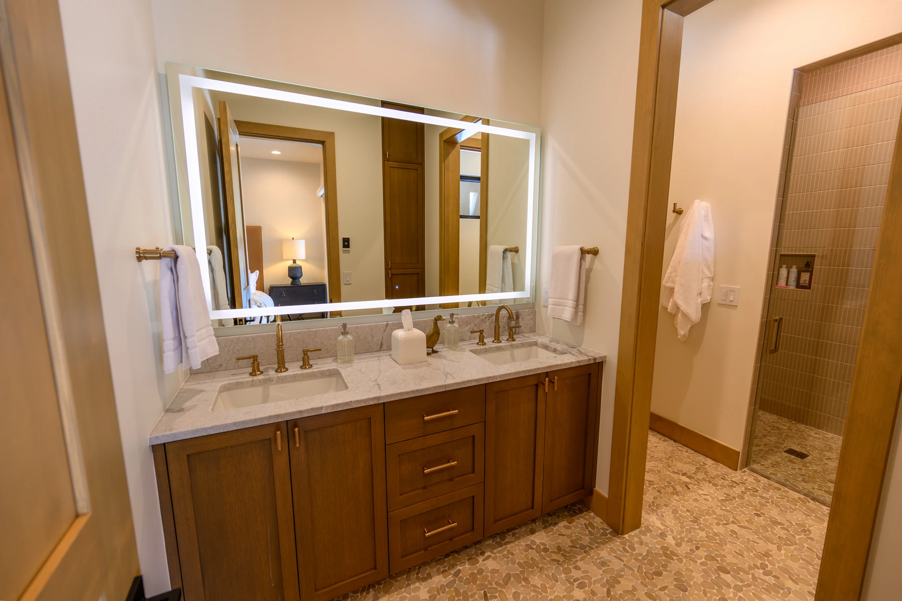 Bathroom in the SlopeSide Escape ski home at Tamarack Resort, with a custom vanity and wood cabinetry.