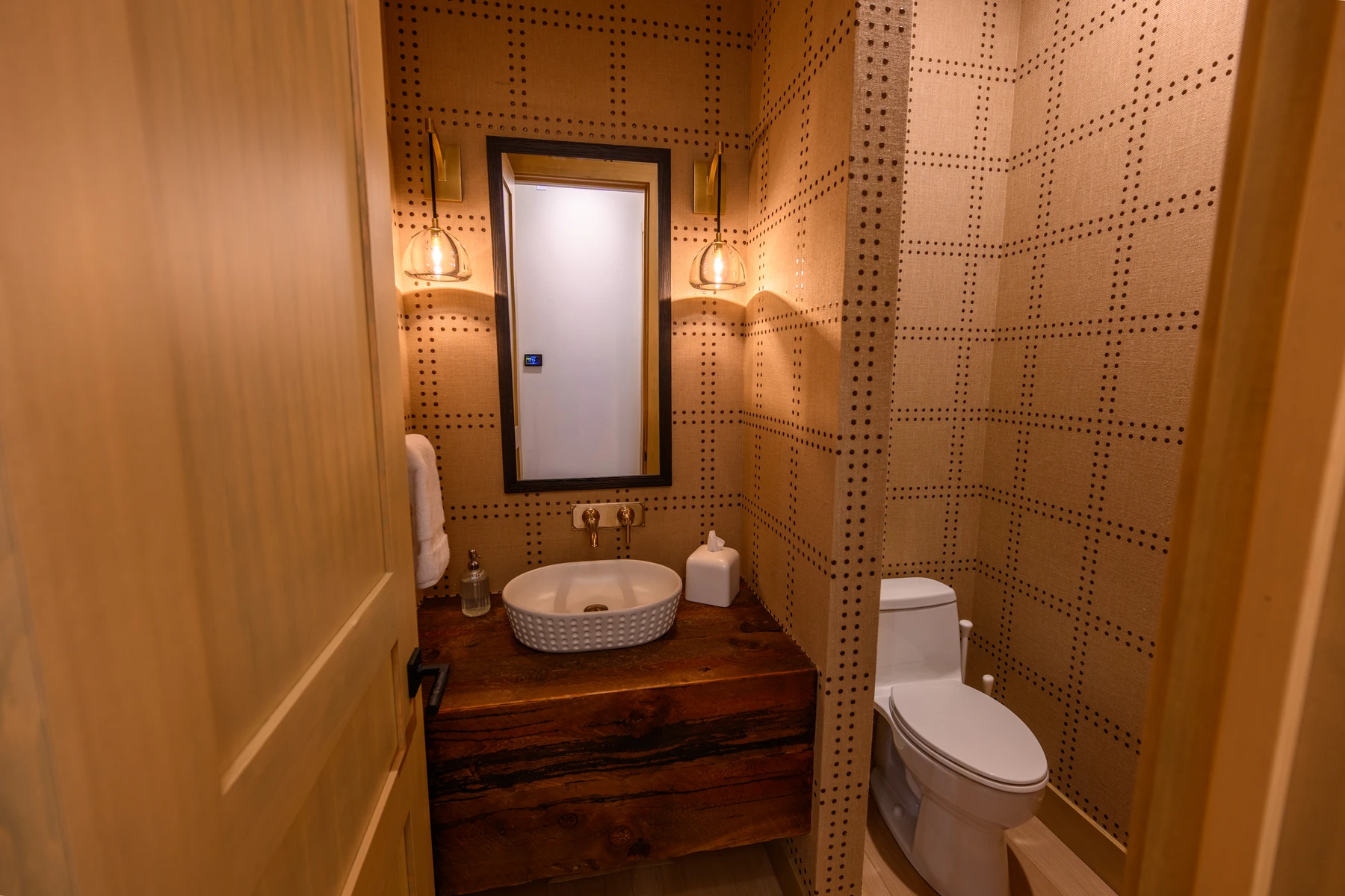 Bathroom in the SlopeSide Escape ski home at Tamarack Resort, with a custom vanity and wood cabinetry.