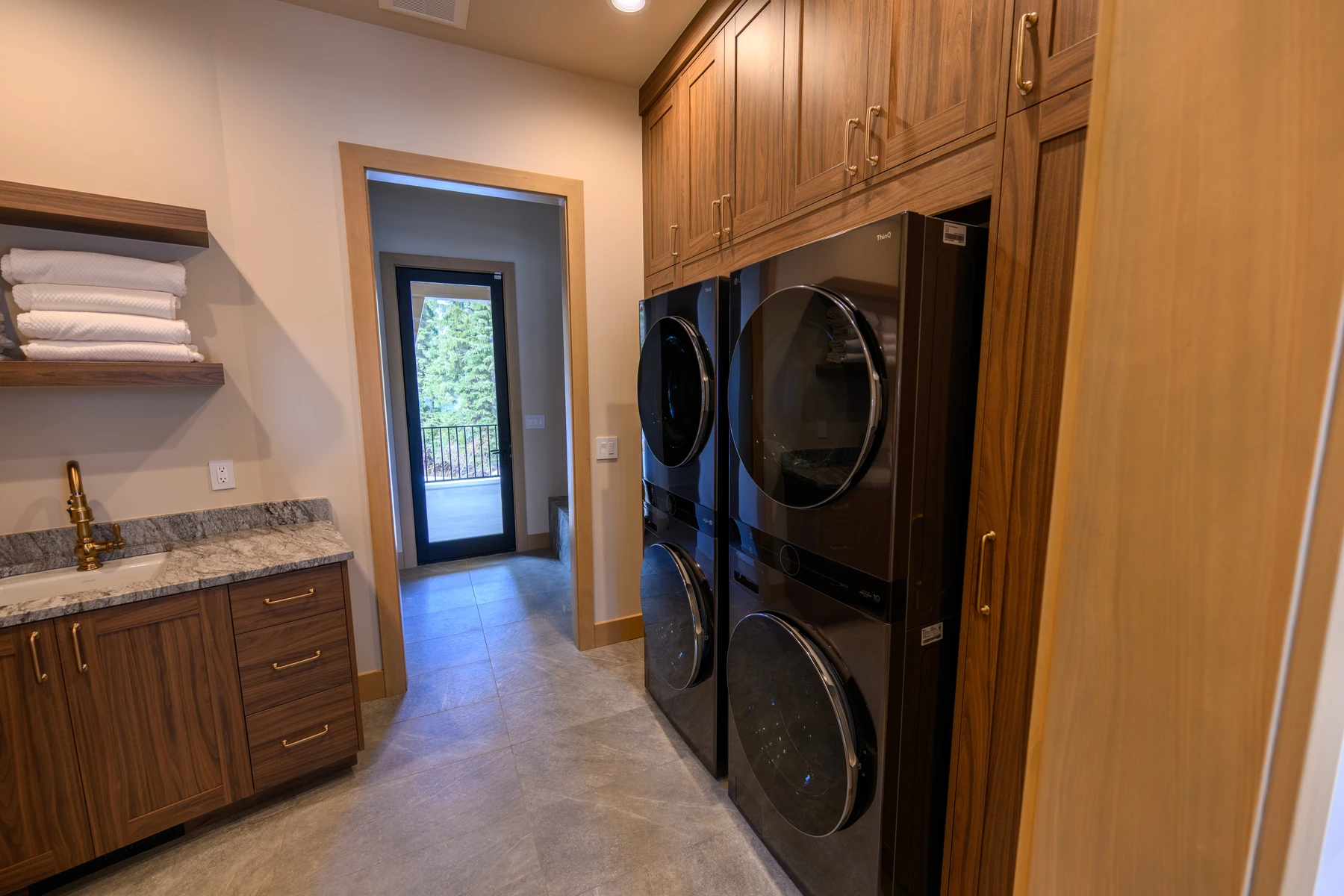 Laundry room in the SlopeSide Escape ski home at Tamarack Resort, with laundry appliances and built-in storage.