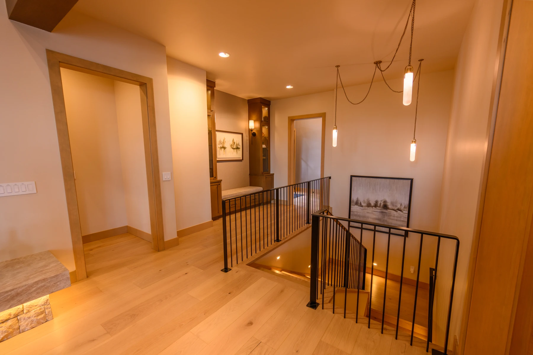 Interior detail in the SlopeSide Escape ski home at Tamarack Resort, showing wood finishes, framed artwork, and decorative lighting.