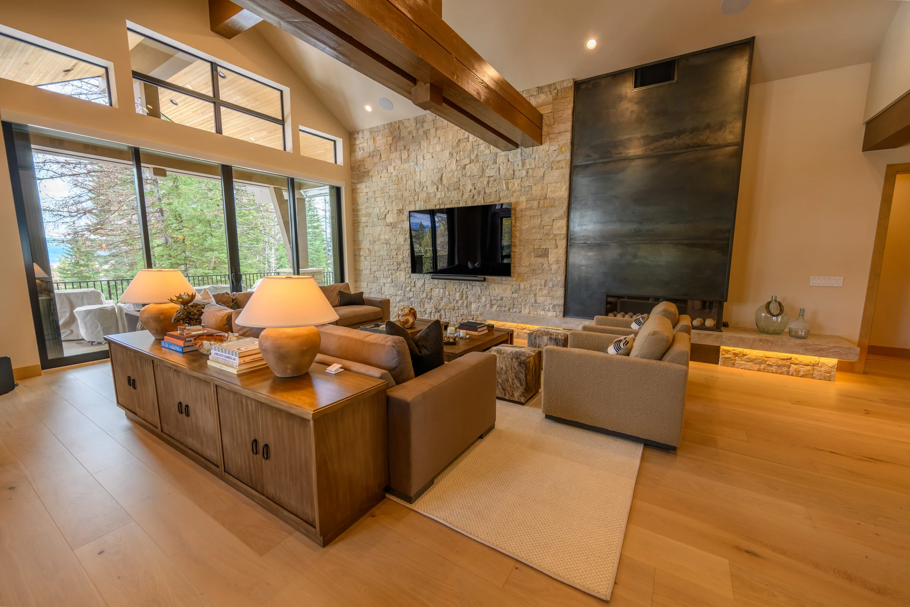 Living room in the SlopeSide Escape ski home at Tamarack Resort, with a relaxed seating area, large windows, and warm wood finishes.