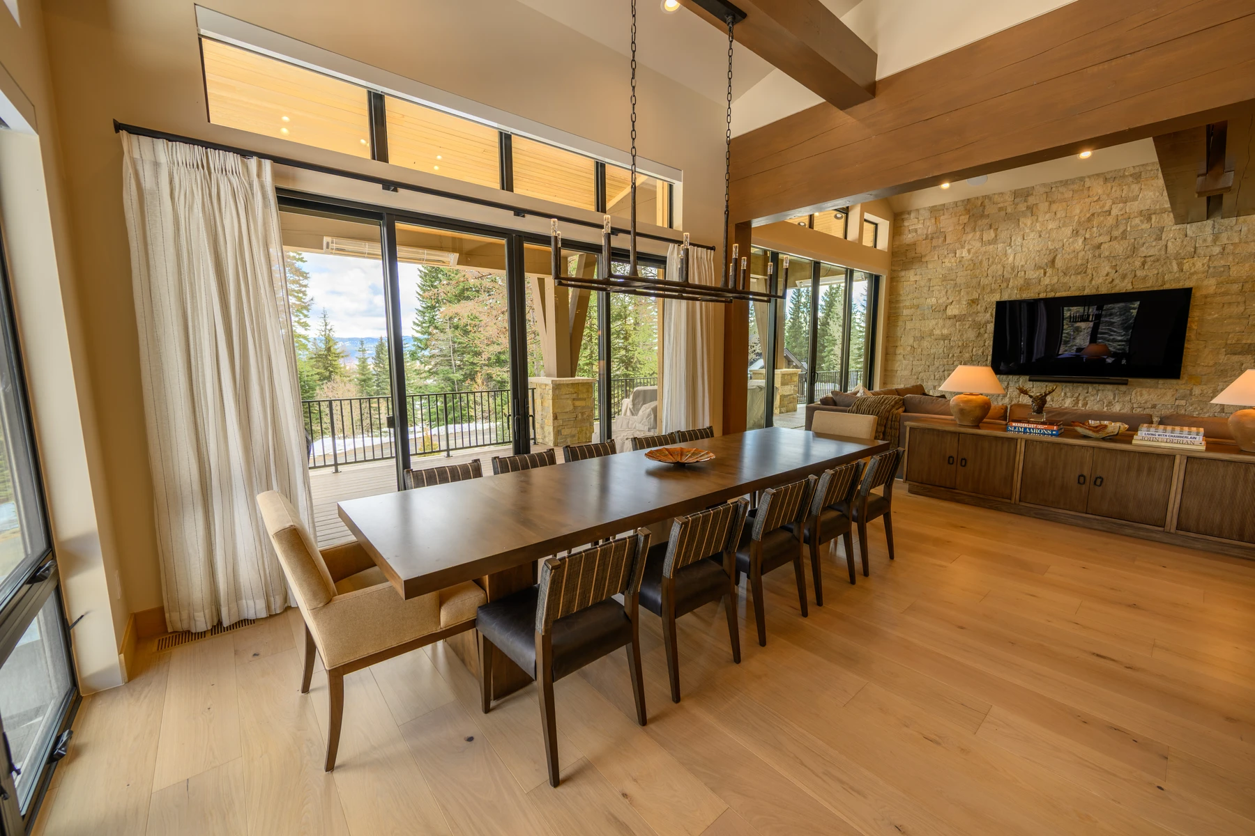 Dining room in the SlopeSide Escape ski home at Tamarack Resort, with a dining table, large windows, and wood finishes.