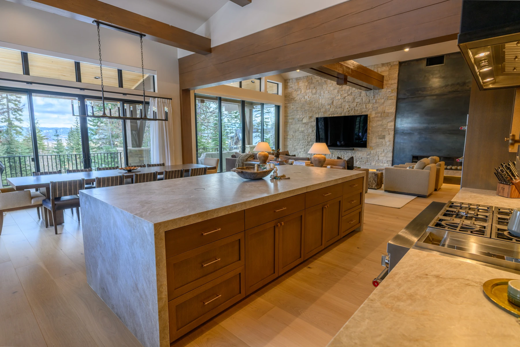 Kitchen in the SlopeSide Escape ski home at Tamarack Resort, with wood cabinetry, a broad countertop, and large windows.