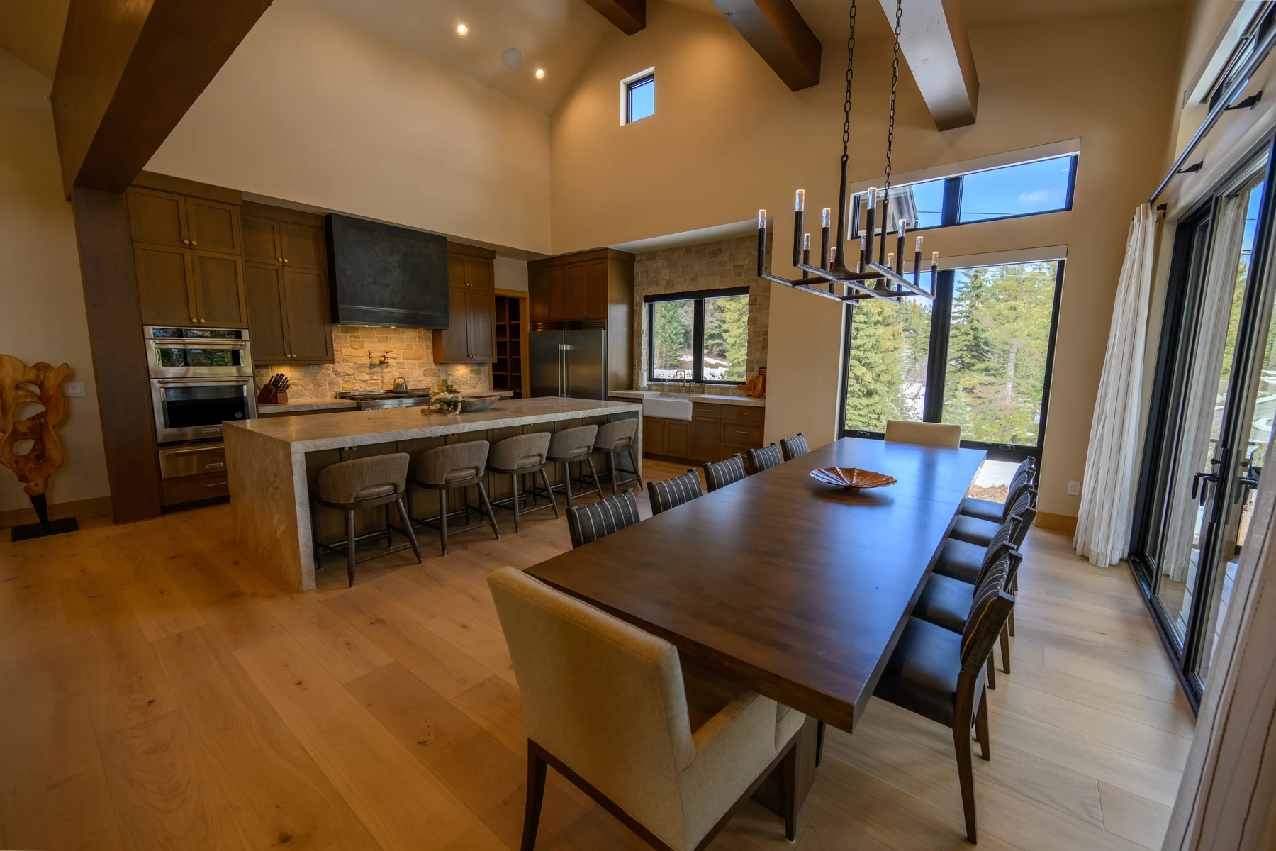 Dining room in the SlopeSide Escape ski home at Tamarack Resort, with a dining table, large windows, and wood finishes.