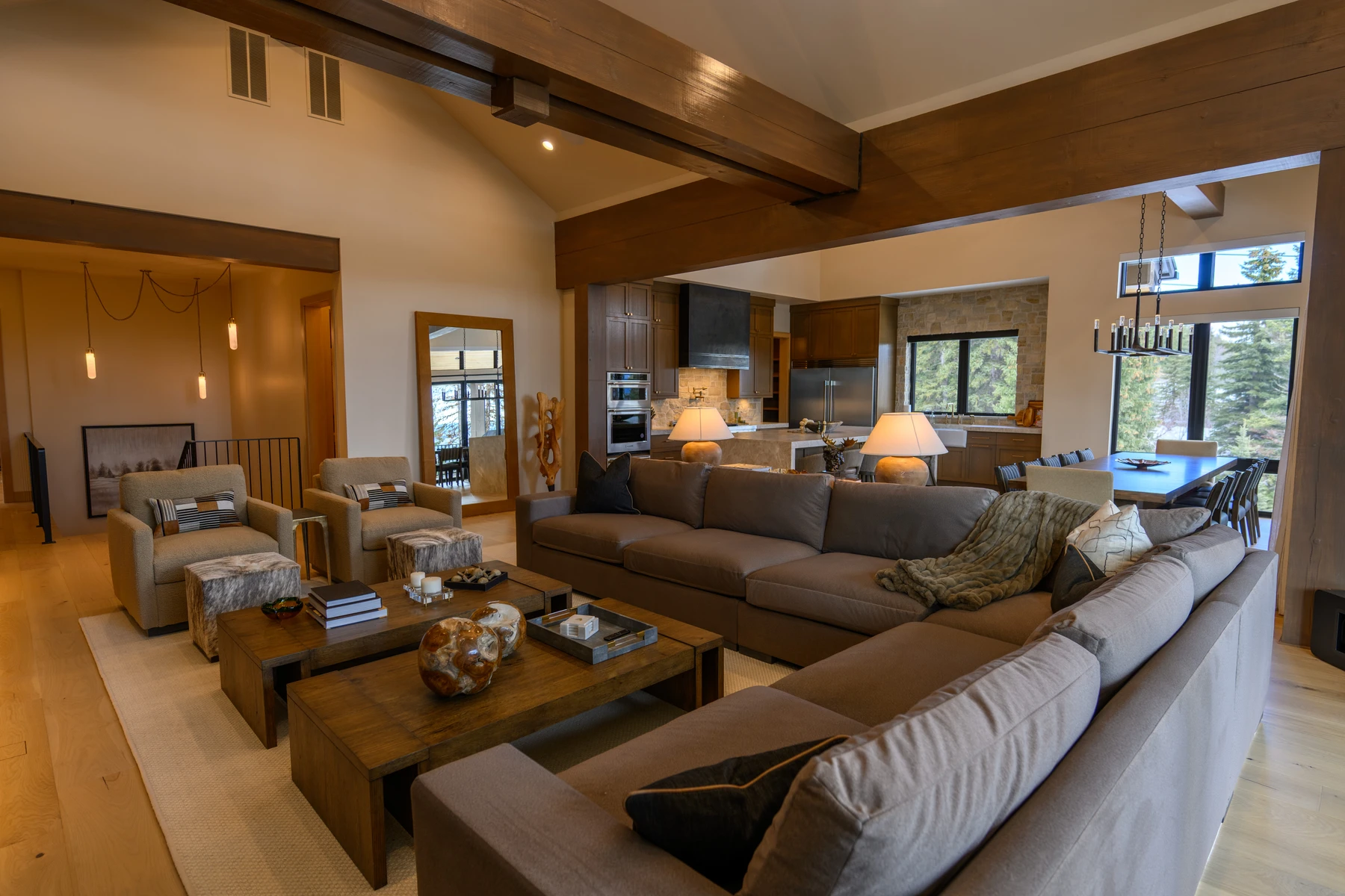 Living room in the SlopeSide Escape ski home at Tamarack Resort, with a relaxed seating area, large windows, and warm wood finishes.