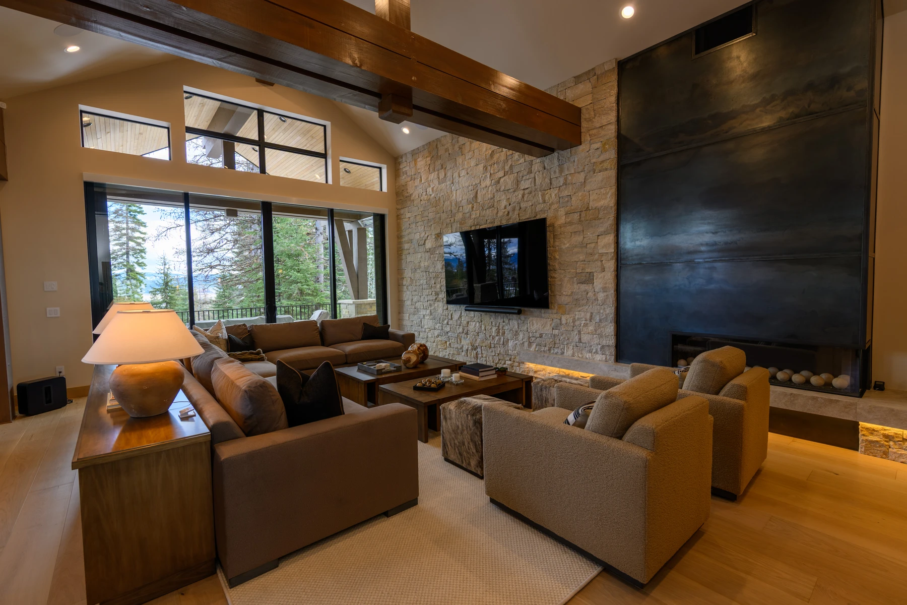 Living room in the SlopeSide Escape ski home at Tamarack Resort, with a relaxed seating area, large windows, and warm wood finishes.