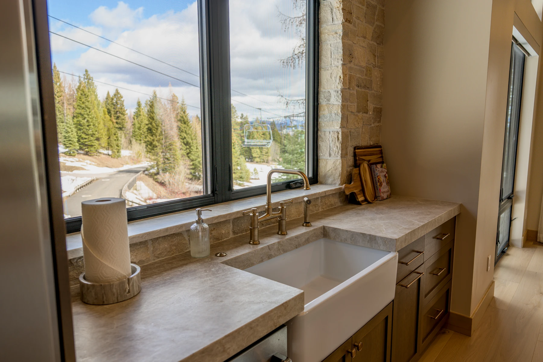 Bathroom in the SlopeSide Escape ski home at Tamarack Resort, with a custom vanity, wood cabinetry, and stone and tile finishes.