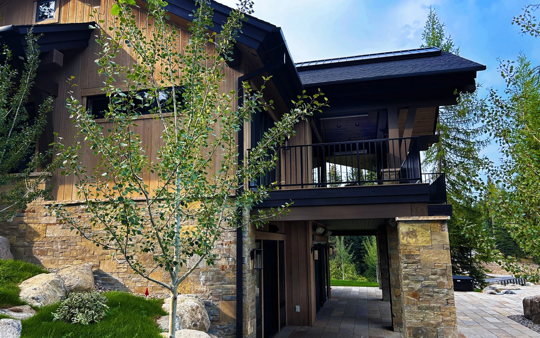 SlopeSide Escape: covered patio and cedar gable at the back of the home