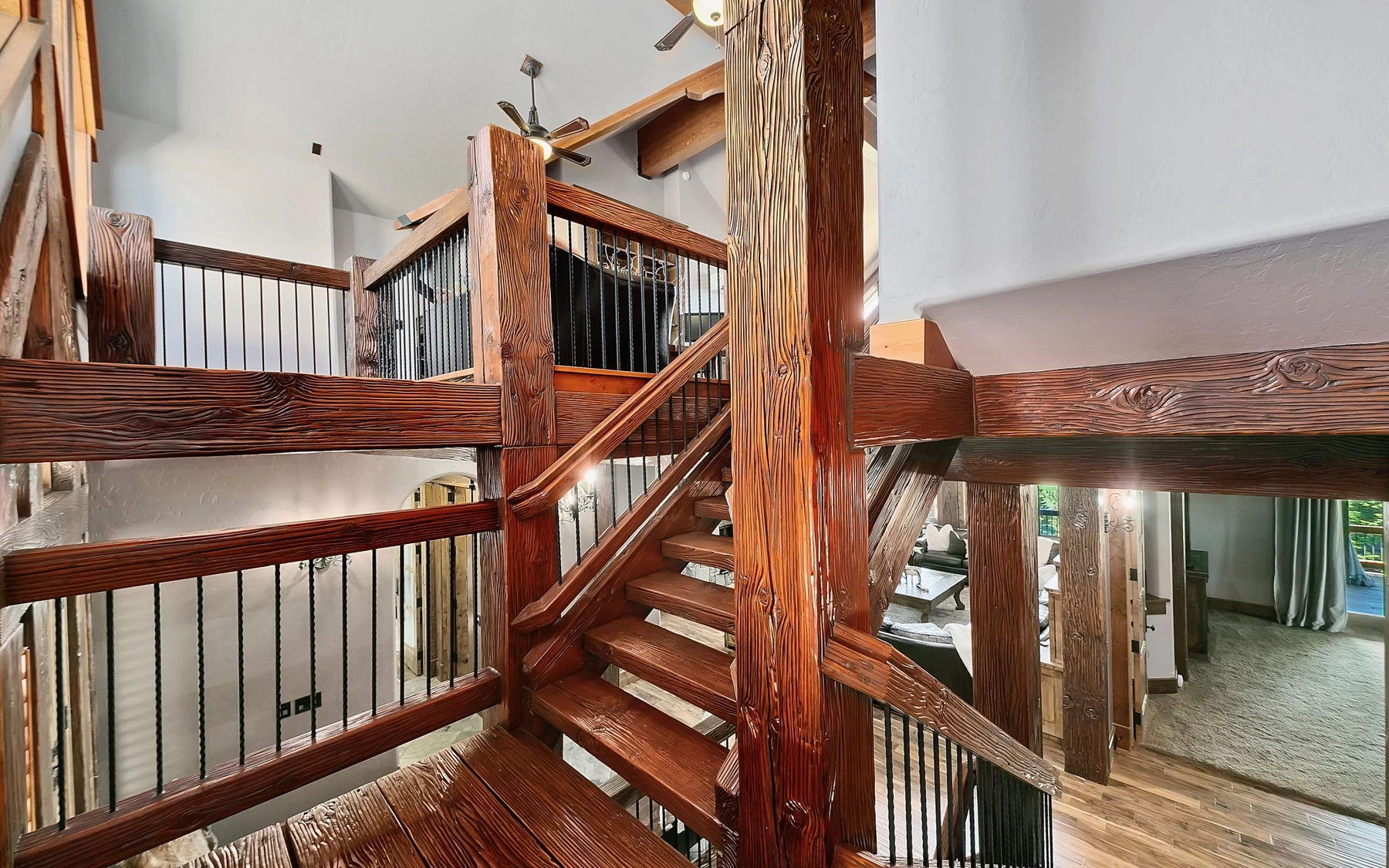Stair hall in the Summit Sanctuary ridgeline home near McCall, with a custom staircase and wood railings.