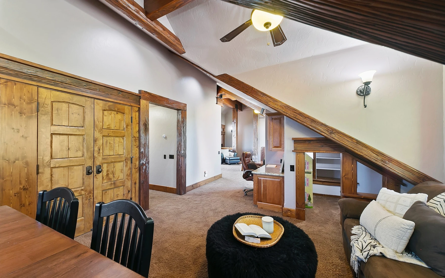 Living room in the Summit Sanctuary ridgeline home near McCall, with a relaxed seating area and warm wood finishes.