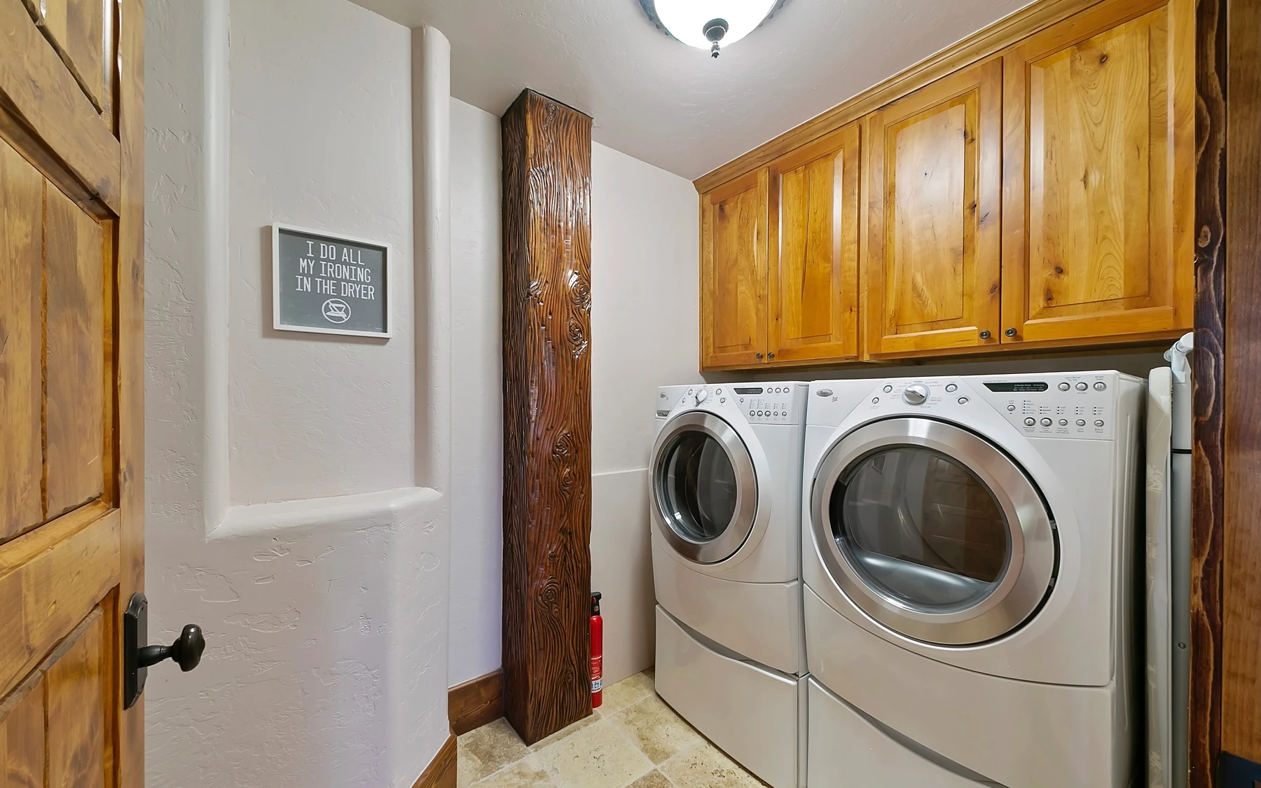 Laundry room in the Summit Sanctuary ridgeline home near McCall, with laundry appliances and built-in storage.