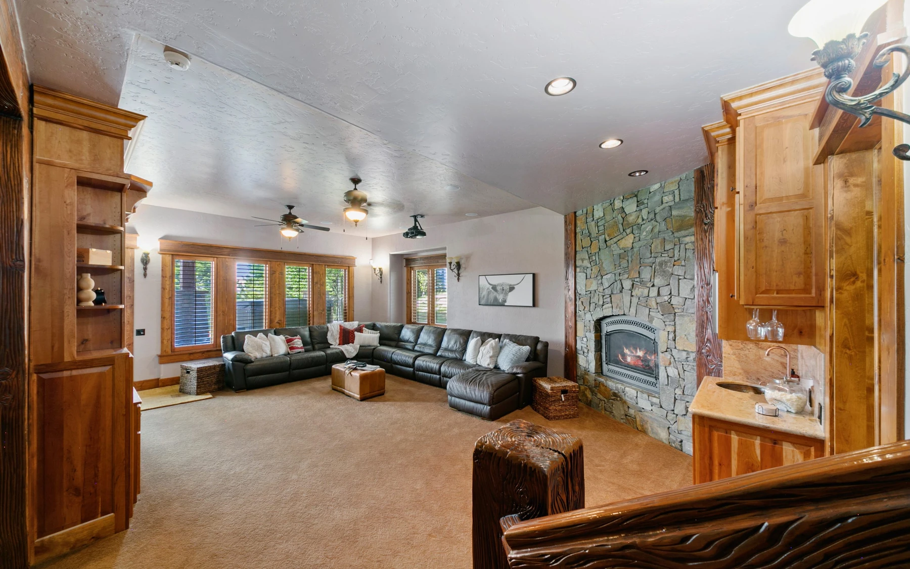Living room in the Summit Sanctuary ridgeline home near McCall, with a relaxed seating area, large windows, and warm wood finishes.