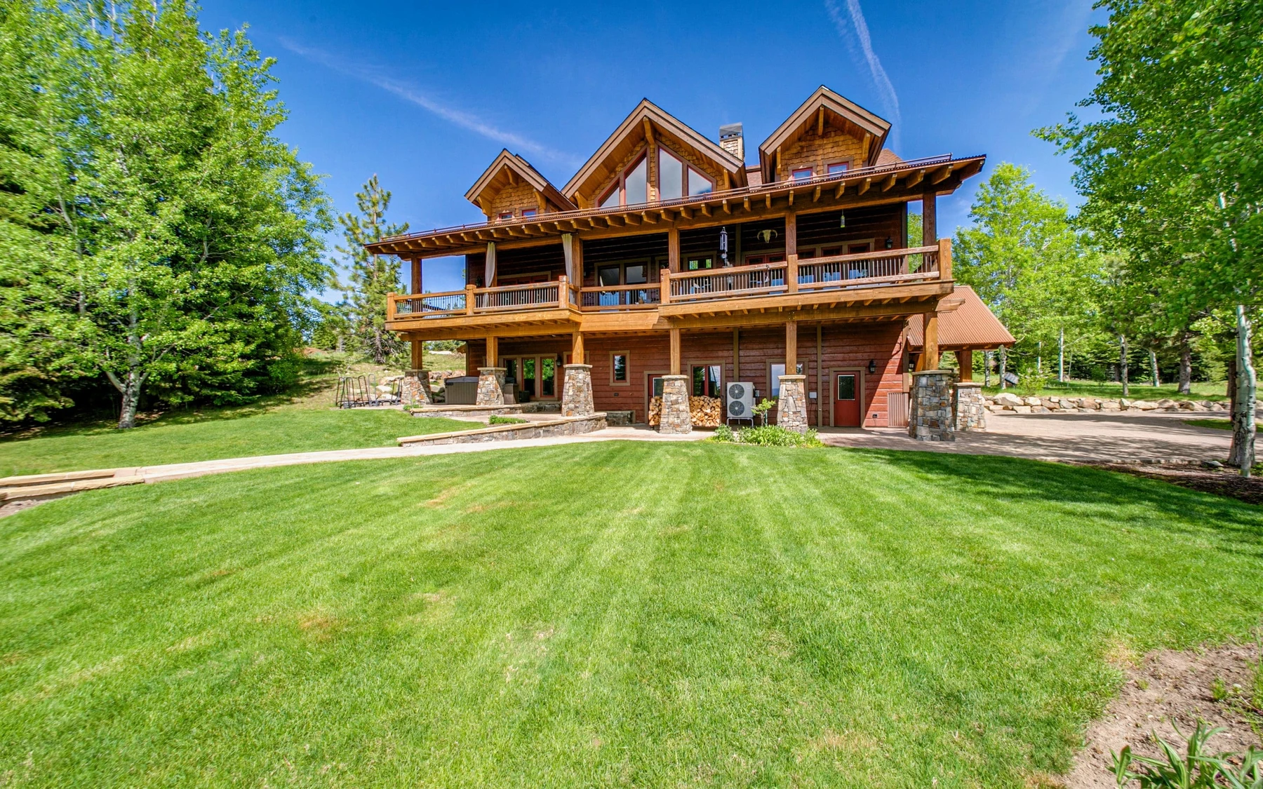 Covered outdoor space at the Summit Sanctuary ridgeline home near McCall, with forest views.