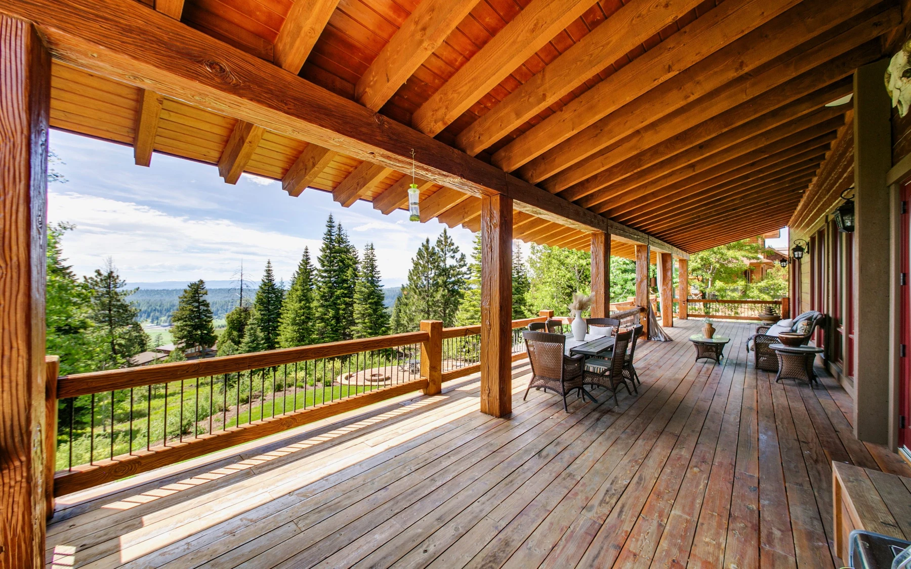 Covered outdoor space at the Summit Sanctuary ridgeline home near McCall, with outdoor seating and timber details.