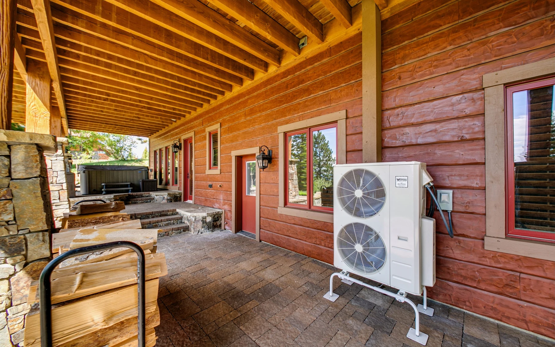 Interior detail in the Summit Sanctuary ridgeline home near McCall, showing large windows, wood finishes, and stone details.