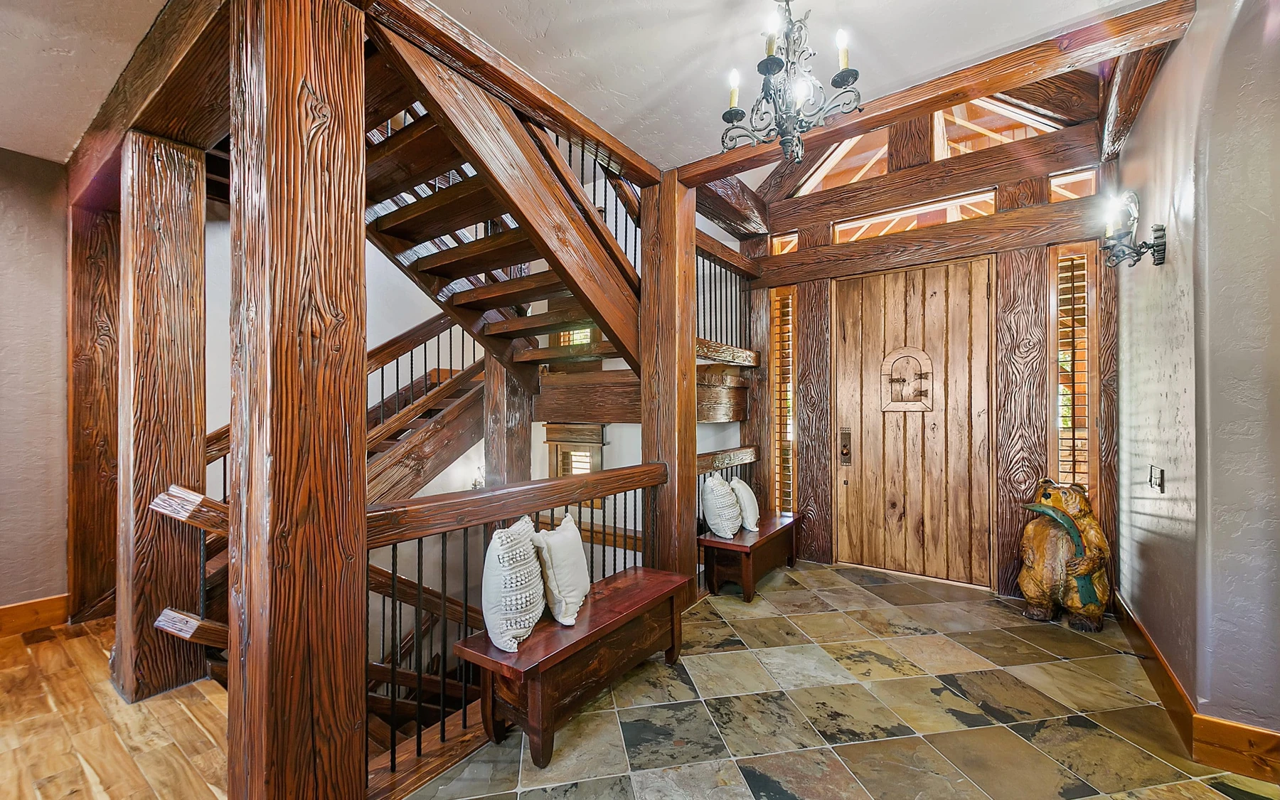 Stair hall in the Summit Sanctuary ridgeline home near McCall, with a custom staircase and wood railings.