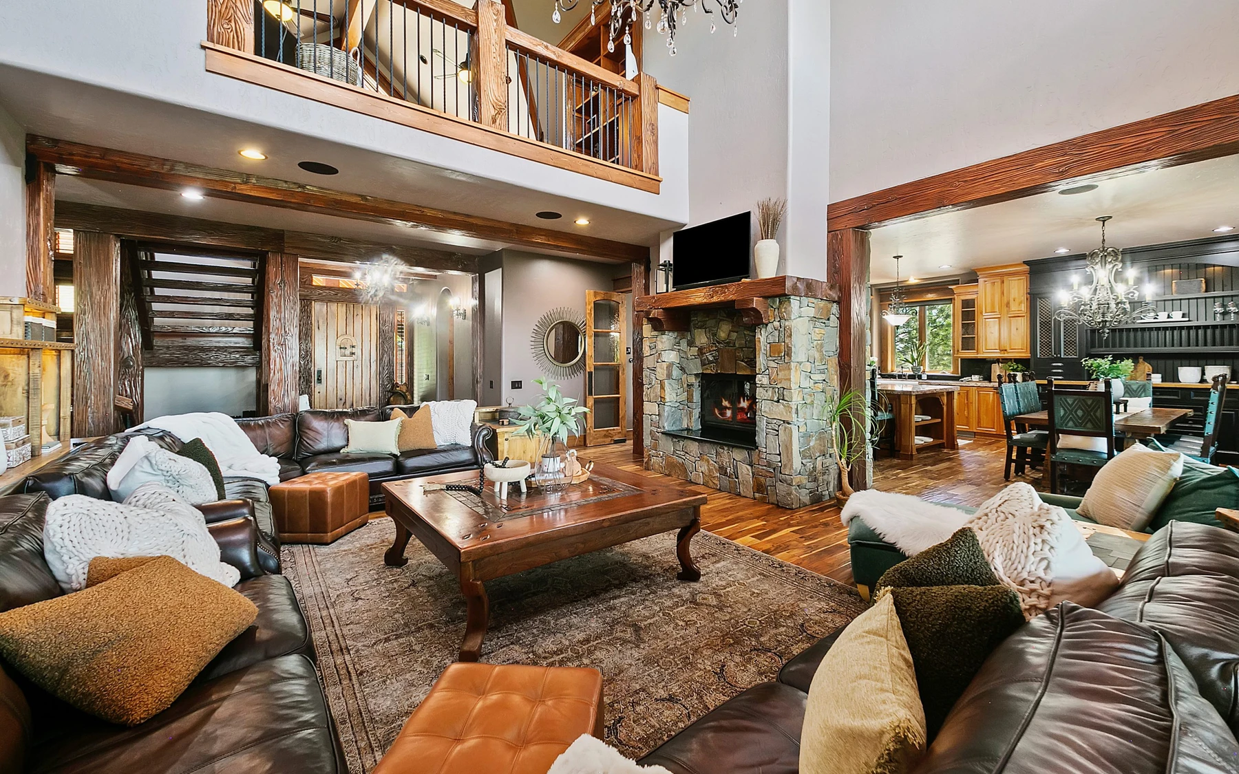 Living room in the Summit Sanctuary ridgeline home near McCall, with a relaxed seating area and warm wood finishes.