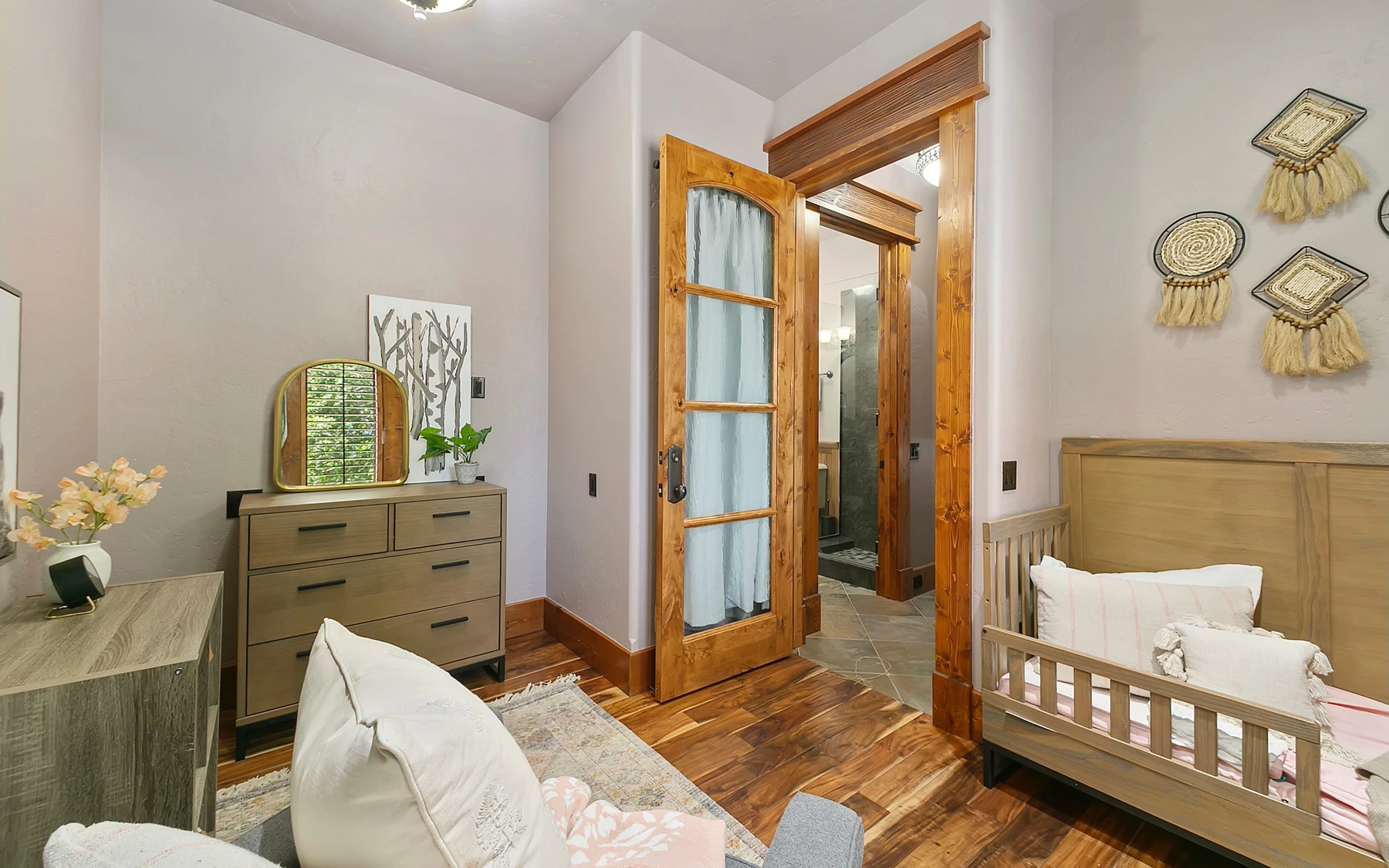 Bedroom in the Summit Sanctuary ridgeline home near McCall, with a layered bed and wood details.